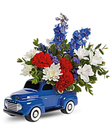 Teleflora's Heyday Ford Pickup Bouquet - Take a spin down sweet street in this vintage, hand-glazed ceramic Ford, bursting with colorful blooms to brighten any occasion! Green carnations, blue delphinium, white daisy spray chrysanthemums, green cushion spray chrysanthemums and blue sinuata statice are arranged with variegated pittosporum and parvifolia eucalyptus. Delivered in a '48 Ford Pickup Keepsake.