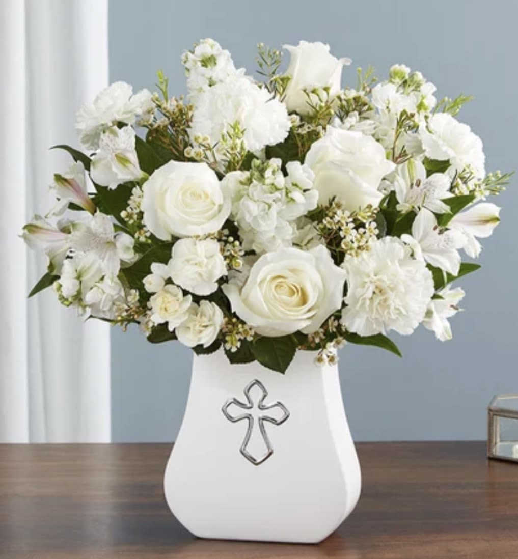 Secret  Blessings  - Pure white flowers have a way of bringing peace to the ones we love during a difficult time. This timeless arrangement is elegantly gathered in our Sacred Blessings vase, featuring a silver-embossed cross: an eternal symbol of hope. A truly comforting gesture to express your deepest condolences.