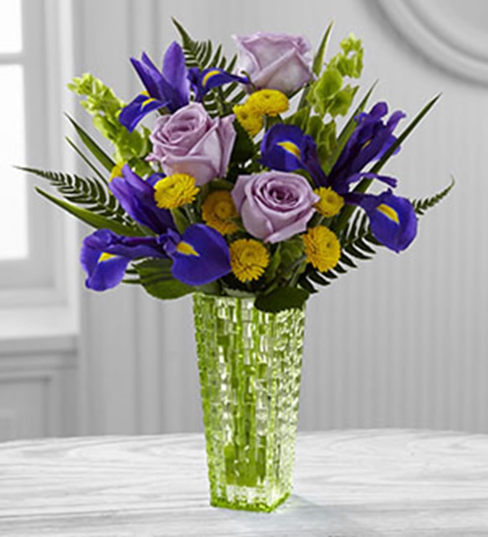 Garden Vista Arrangement by Better Homes and Gardens - Bring love and light into their day with this exquisite rose and iris bouquet! This flower arrangement is a wonderful gift set to celebrate a birthday, to offer your congratulations or to extend your get well wishes.   DETAILS Lavender roses, purple iris, yellow button poms, Bells of Ireland and sword fern are delicately arranged to create an impressive flower arrangement.   VASE INCLUDED Orientation: One-Sided Item #NF-381  FLORIST-TO-DOOR Same day flower delivery on most orders placed online by 12 pm or 10 am on weekends PST.  BLOOM DETAILS Roses Bells of Ireland Iris Button-Mums Greenery  The Standard Arrangement is approx. 14&quot; H x 12&quot; W. The Deluxe Arrangement is approx. 14&quot; H x 14&quot; W. The Premium Arrangement is approx. 15&quot; H x 14&quot; W.  How to place an order? 1. You can place an order directly on this secure website OR 2. You can call in your order by dialing: (323) 262 - 9238 OR 3. You can visit our store (appointment recommended 323.262.9238)  NINFA'S FLOWERS 2405 WHITTIER BLVD. LOS ANGELES, CA. 90023  ATTENTION: *Please note that on busy holidays, Valentine's Day, and Mother's Day, we cannot verify if the recipient received the flowers until the following day. You can verify delivery on the website after 10:00 pm, call 323.262.9238 the following day after 10:00 am, or contact the recipient directly. Thank you for your patience and understanding. 
