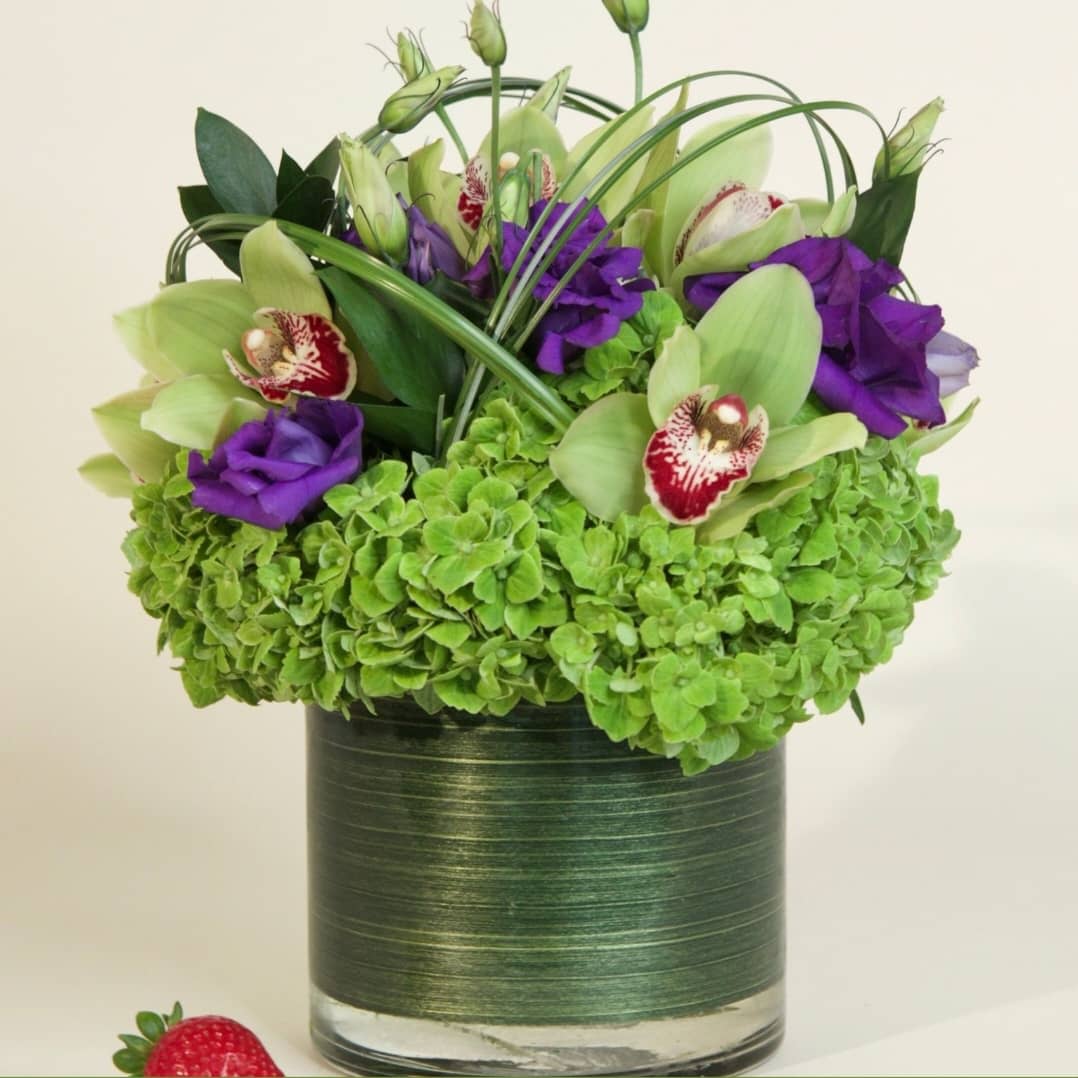 Bright Abundance  - This cylindrical vase of flowers is kind of like a time capsule, if time were made of flowers. What a wonderful “time” that would be. In the season of changing plants, leaves, and flowers, this cylinder of bright abundance reminds us of the beauty that comes with the changing of the seasons. Spoiler alert: that’s a lot of beauty.