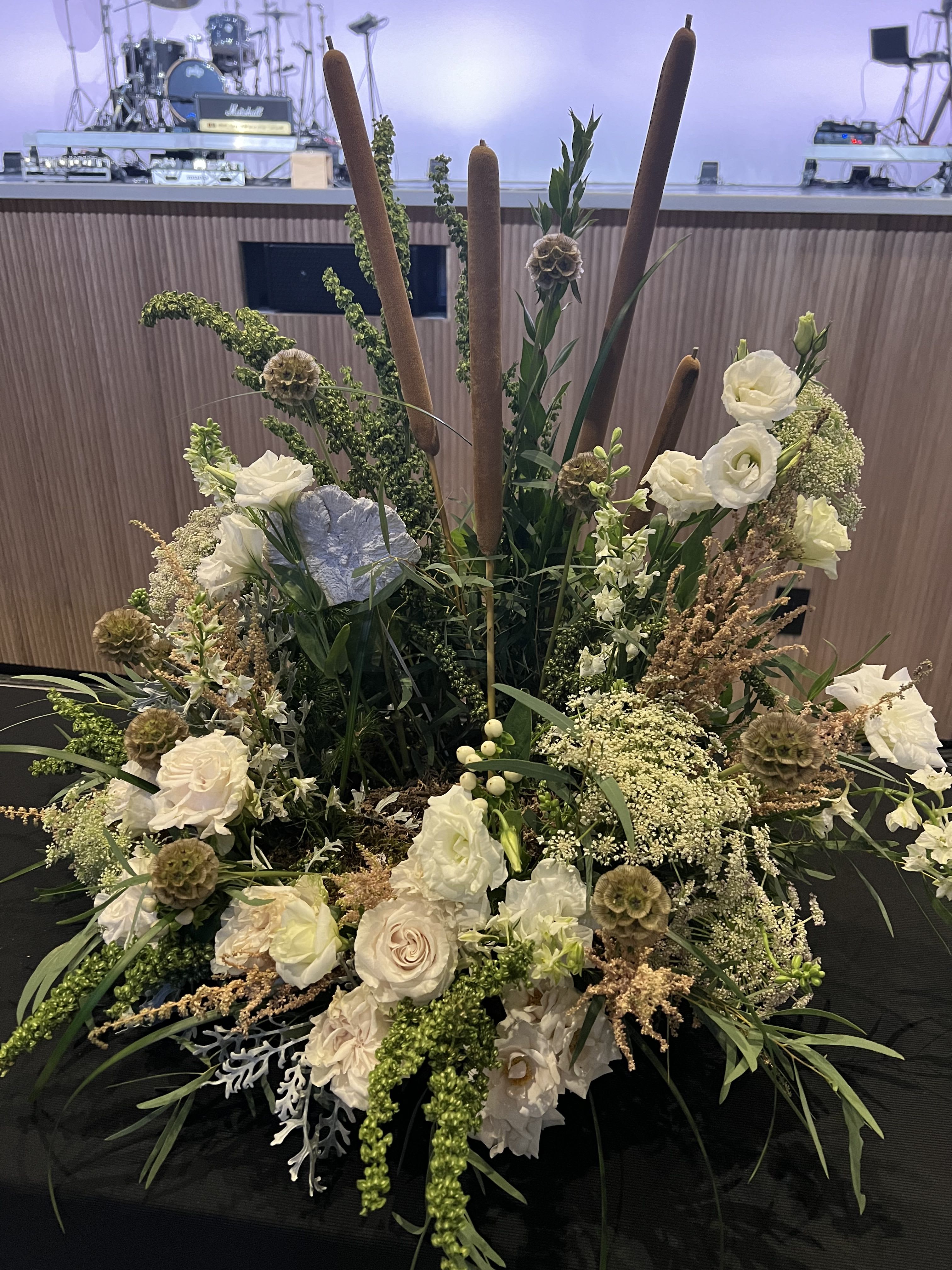 Seasons in the Sun - A sympathy arrangement that beautifully honors the love of the beach while conveying heartfelt condolences.  White roses and delicate astilbe add a feathery texture evoking the tranquility of a beachside setting. 