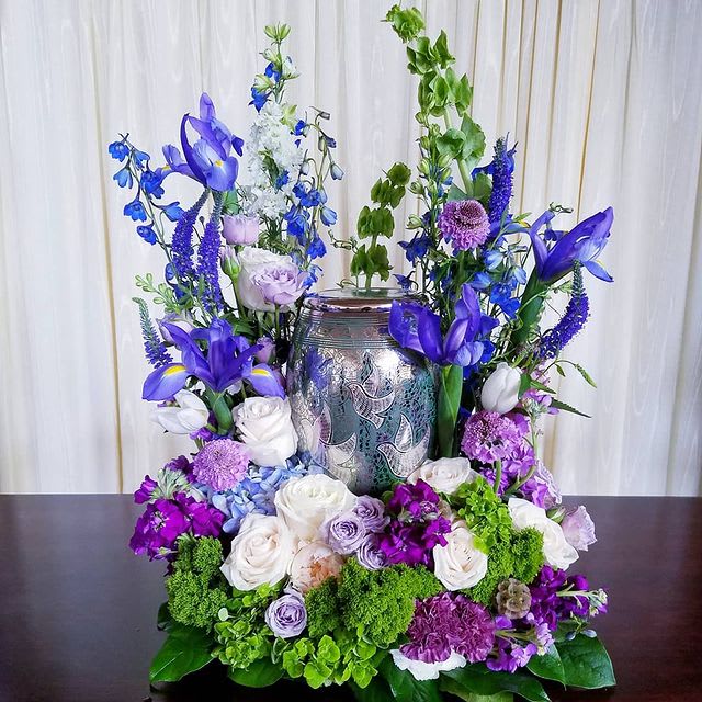 Serenity - Beautiful blooms of delphinium, iris, bells of Ireland, and roses adorn this loved ones urn.