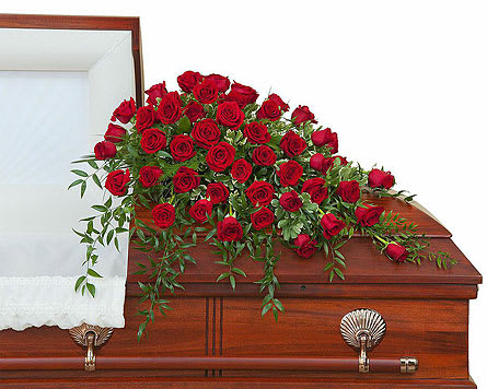 Simply Roses Supreme Casket Spray - An abundance of red roses with premium foliage in a casket spray. Approximately 40&quot; wide 36&quot; deep As Shown : 