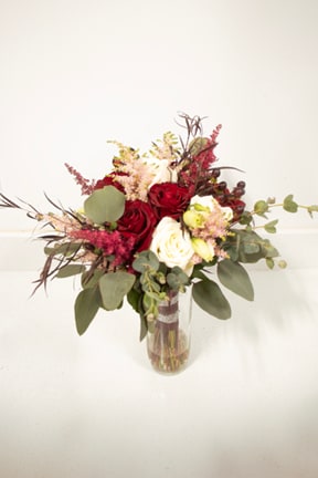 Bridal Bouquet Love’s Symphony - Introducing the Love’s Symphony bouquet, a harmonious blend of classic elegance and romantic charm. This exquisite arrangement features pristine white and passionate red roses, symbolizing unity and deep affection. Delicate astilbe adds a touch of airy grace, while vibrant hypericum berries provide a playful pop of color and texture. Perfect for celebrating love, or simply brightening someone’s day, the Love’s Symphony bouquet is a timeless expression of beauty and heartfelt sentiment. Let this stunning arrangement compose the perfect message of love and admiration for someone special.