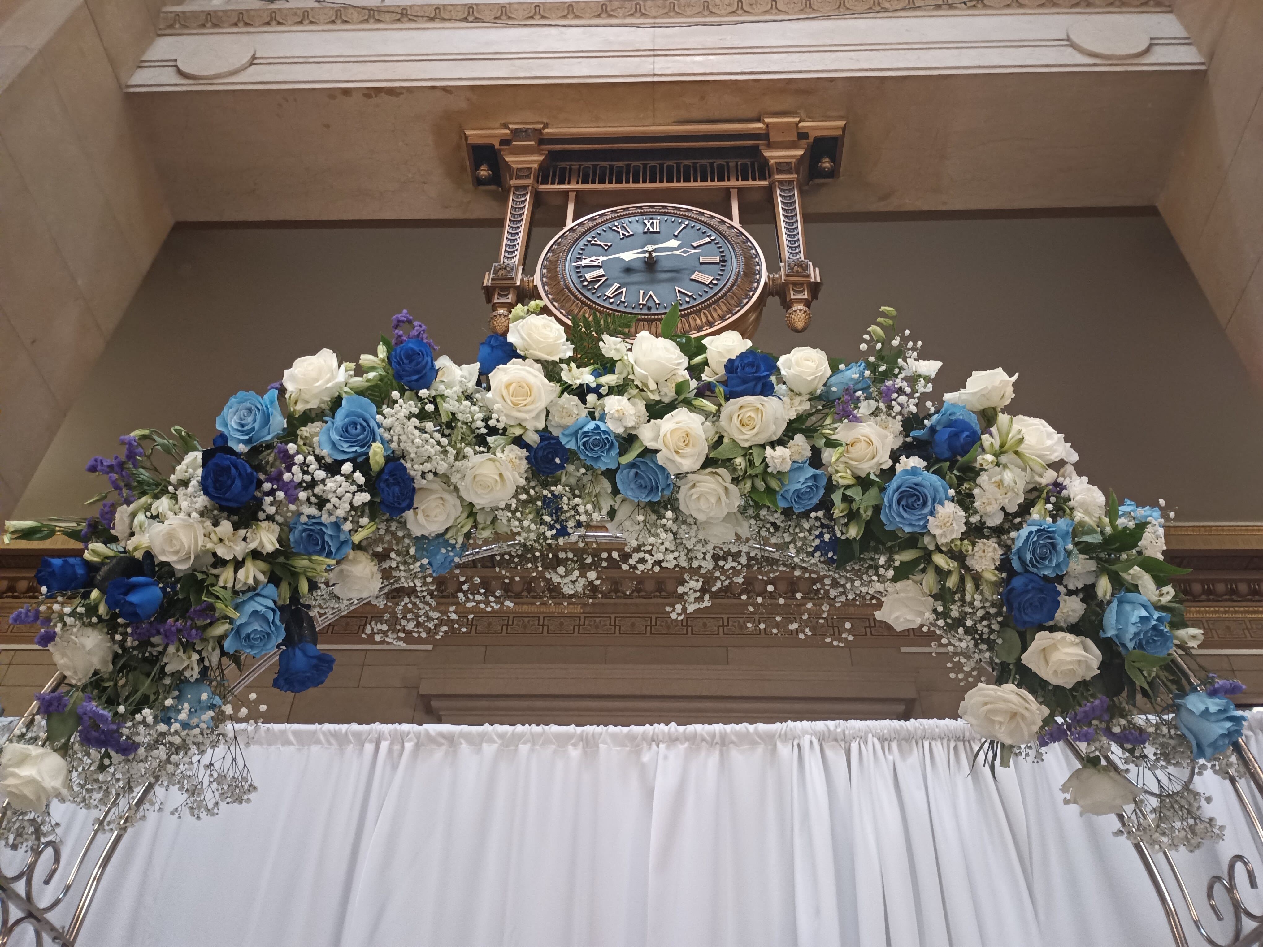 Dana C wedding ceremony arch - Beautiful mix of unusual light and dark blue roses, white roses, alstroemeria, carnations, baby's breath ad greens