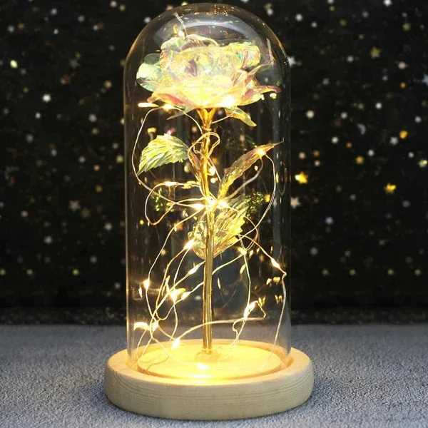 Enchanted Galaxy Rose in a Glass Dome Enchanted Galaxy Rose in a Glass Dome - Inspired by Beauty and the Beast, the never fade Enchanted Galaxy Rose in a glass dome represents Faith in Love Forever. It is a special way of telling her or him "Love you more as time goes by". Great for home decor would look amazing anywhere you want. Great gift for Birthdays, Christmas, Valentine's Day, Mother's Day, Anniversary, Wedding and more. Our Enchanted Galaxy Rose creates a nice and comforting feeling in the house when spending time with your family.  CREATIVE, DECORATIVE, UNIQUE, LED LAMP This stylishly designed Enchanted Galaxy Rose brings any room to life. With around 20 bulbs of subtle warm white light and constant lighting mode, it provides great mood lighting and can be placed anywhere. This table lamp is an excellent focal point in an office, bedroom or living area. Requires 3 AAA Batteries.  PREMIUM DESIGN The Enchanted Galaxy Rose is 5.52" x H 9.65", Real Glass cover allows LED light to shine more brilliantly than a plastic cover, resists yellowing & discoloration, and is easier to clean. The tiny LED lights are embedded in the petals, from the rose to the petals falling on the base, the warm white light illuminates the entire glass dome and even the surrounding things. Warm white light not only benefits our eyes but also gives us a romantic atmosphere.