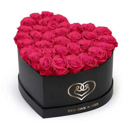 Hot Pink Roses | Black "Love" Box Hot Pink Roses | Black "Love" Box - The "heart box collection" consists of unique, real preserved roses handcrafted, soft, and elegant heart box with a top. Luxury arrangement of about 31 stems of the one long lasting (med size) real preserved roses.  Durability: approx. 1-3 years.  Our roses, which are carefully sourced from the highest quality gardens in Ecuador, are made to represent the eternal yet ephemeral nature of Love itself. Our Roses are specially customized with essential oils to increase the fragrance.  Product Care: DO NOT Water the roses! AVOID direct exposure to sunlight. Keep the arrangement in a room-temperature environment. If dust collects after a few months, remove it lightly using a duster. DO NOT place anything onto the roses as they can crush and damage the roses. DO NOT remove the roses from the box; they are secure and happy there. DO NOT allow roses to have direct contact with light colored fabric or surfaces, as staining may occur. The lid is meant to stay on the side or bottom of the box. Be mindful when carrying the arrangement: it's a very delicate product!