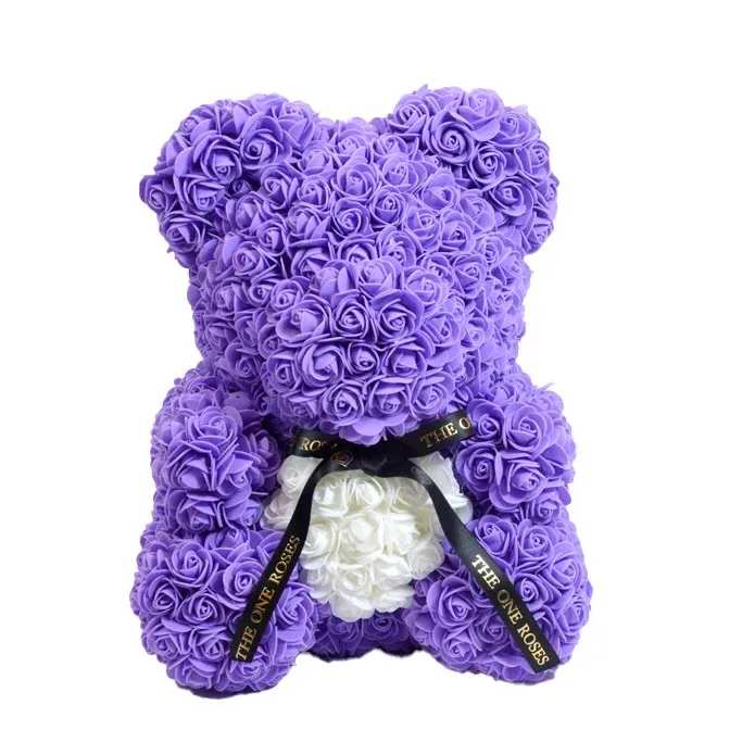Purple White Heart Rose Bear Purple White Heart Rose Bear - Give someone special our gorgeous The One Rose Bear handmade of roses that last forever.  The perfect gift that will look great as a decoration piece in your loved one's home or office. Designed with synthetic roses in beautiful colors, this handmade Rose Bear lasts a lifetime with no care needed!  The best gift for Birthdays, Christmas, Valentine's Day, Mother's Day, Anniversaries, Baby Showers, Gender Reveal, Proposals, Weddings, or any occasion that warrants such a unique and precious gift.  Our authentic Rose Bear comes with our The One Roses Satin Bow and is available only in medium (14 inch) size.  What's Included?  The One Roses Signature Gift Box The One Roses Satin Ribbon The One Roses Rose Bear of your choice of color