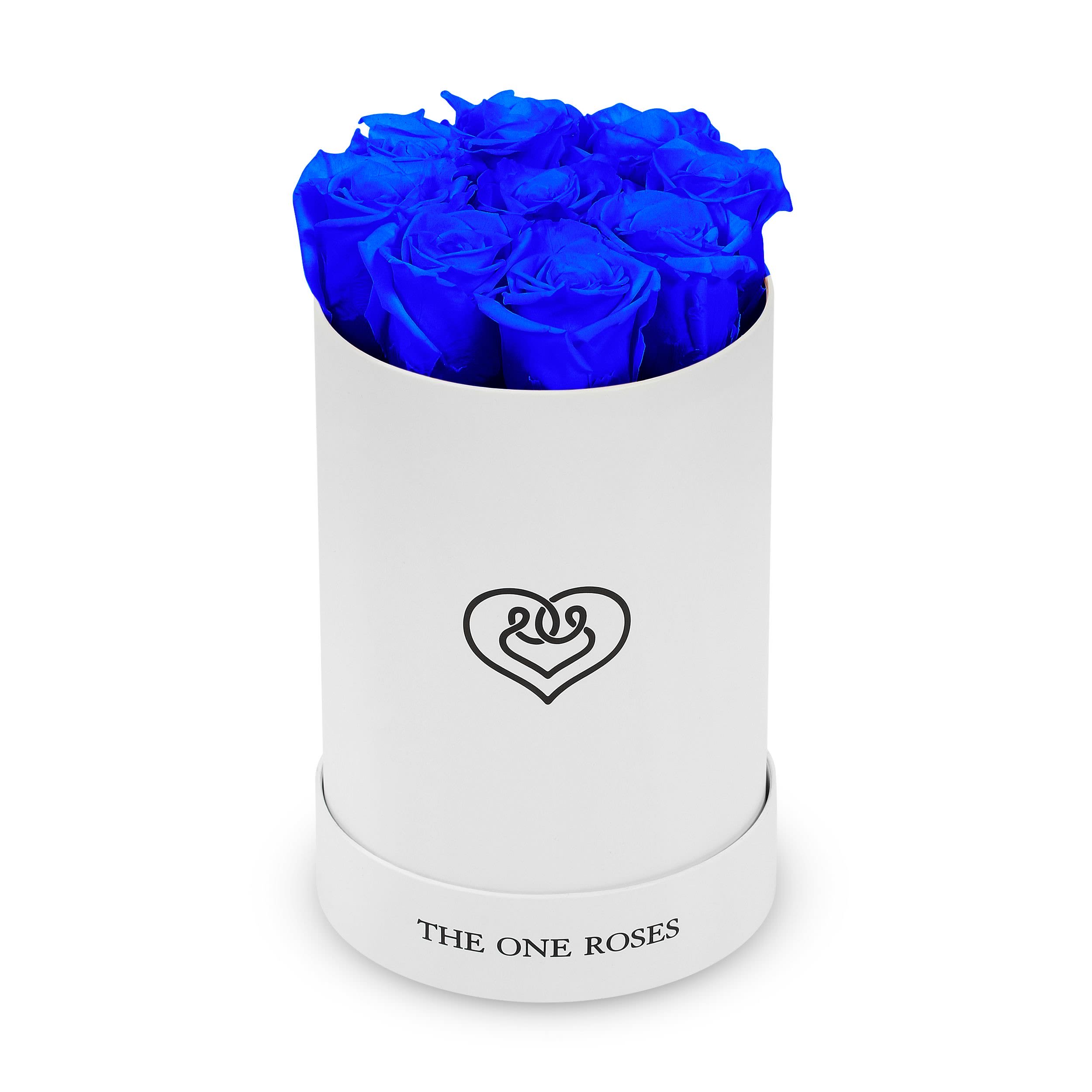 Round Flat | Basic White Box Sapphire Blue Round Flat | Basic White Box Sapphire Blue - The "runway round collection" consists of unique, real preserved roses in basic round handcrafted luxury soft touch box with a top. About eight to nine stems of the one long lasting (med size) preserved roses.  Durability: approx. 1-3 years.  Product Dimension: 6″× 8″ /8- 9 ROSES  Our roses, which are carefully sourced from the highest quality gardens in Ecuador, are made to represent the eternal yet ephemeral nature of Love itself. Our Roses are specially customized with essential oils to increase the fragrance.  Product Care: DO NOT Water the roses! AVOID direct exposure to sunlight. Keep the arrangement in a room-temperature environment. If dust collects after a few months, remove it lightly using a duster. DO NOT place anything onto the roses as they can crush and damage the roses. DO NOT remove the roses from the box; they are secure and happy there. DO NOT allow roses to have direct contact with light colored fabric or surfaces, as staining may occur. The lid is meant to stay on the side or bottom of the box. Be mindful when carrying the arrangement: it's a very delicate product!