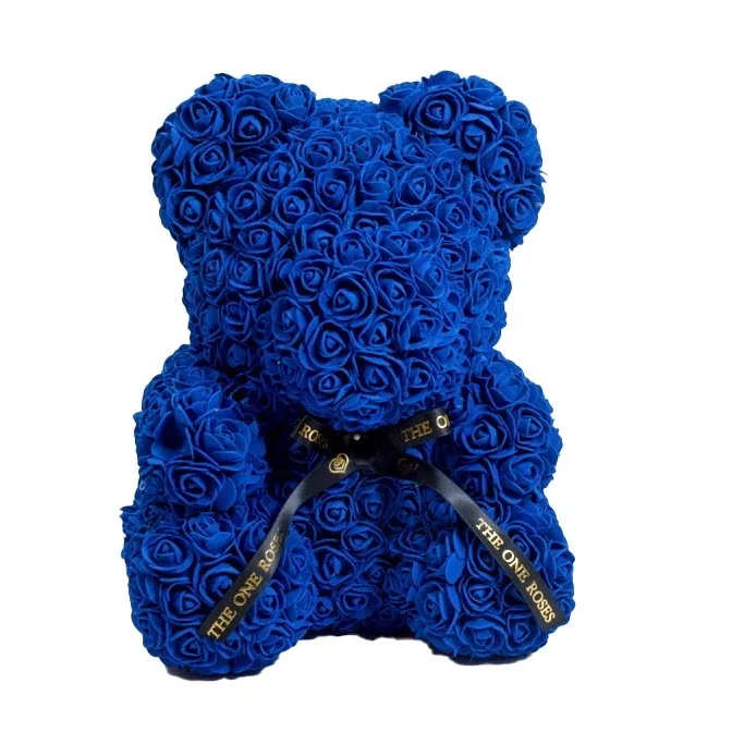 Sapphire Blue Rose Bear Sapphire Blue Rose Bear - Give someone special our gorgeous The One Rose Bear handmade of roses that last forever.  The perfect gift that will look great as a decoration piece in your loved one's home or office. Designed with synthetic roses in beautiful colors, this handmade Rose Bear lasts a lifetime with no care needed!  The best gift for Birthdays, Christmas, Valentine's Day, Mother's Day, Anniversaries, Baby Showers, Gender Reveal, Proposals, Weddings, or any occasion that warrants such a unique and precious gift.  Our authentic Rose Bear comes with our The One Roses Satin Bow and is available only in medium (14 inch) size.  What's Included?  The One Roses Signature Gift Box The One Roses Satin Ribbon The One Roses Rose Bear of your choice of color