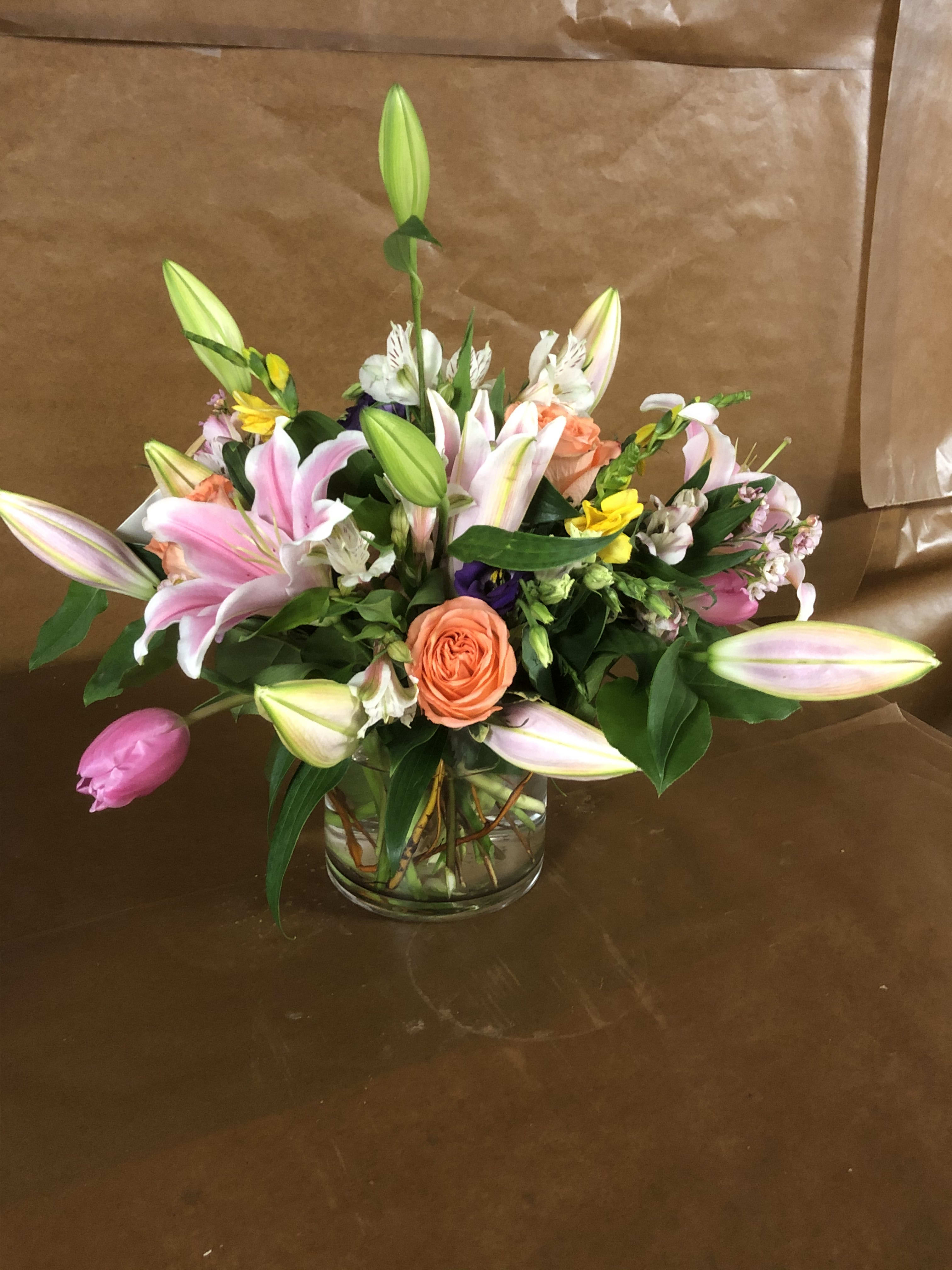 DESERT WIND - Lilies, roses, tulips; yellows, purples and pinks.