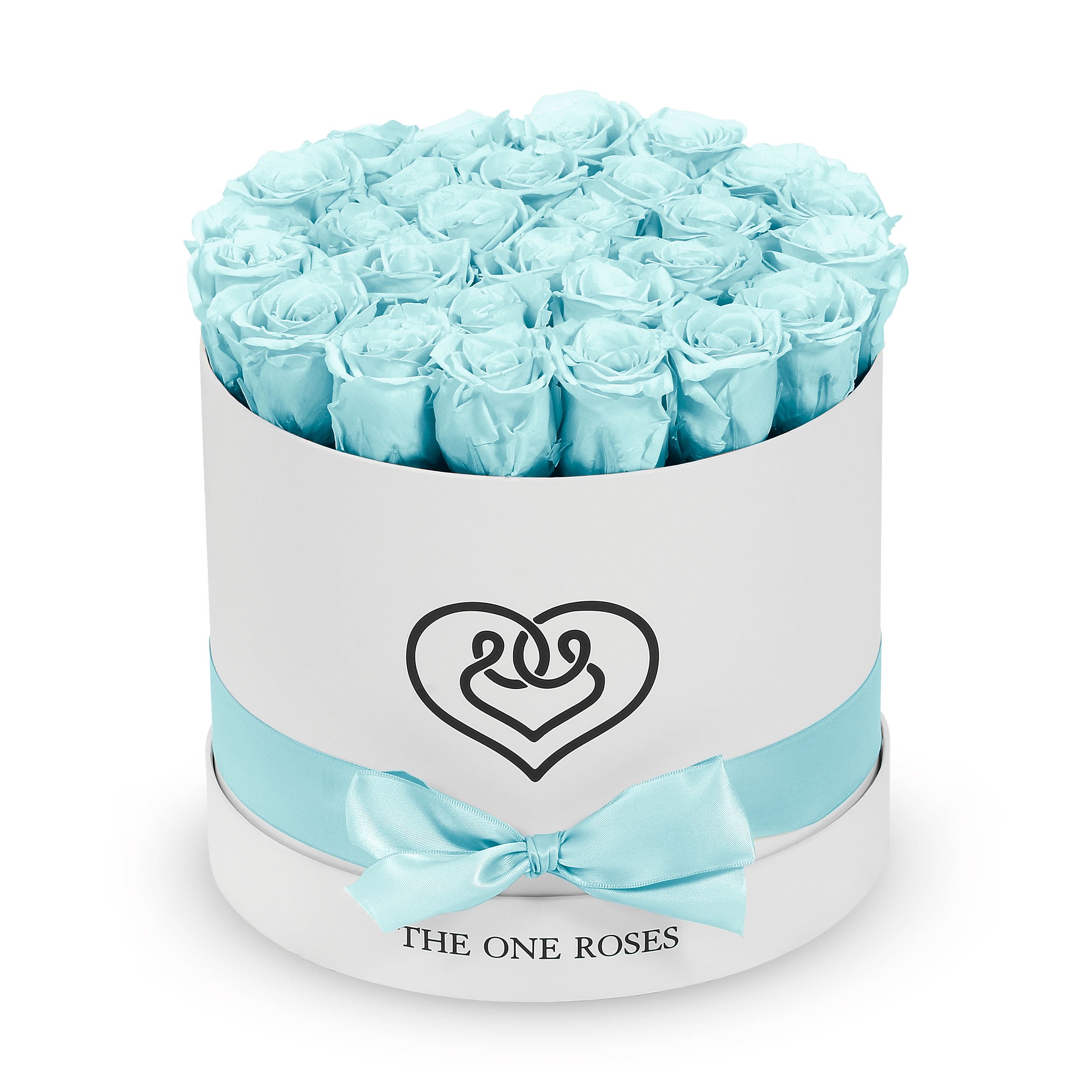 Round Flat | Classic White Box Frozen Blue Round Flat | Classic White Box Frozen Blue - The "runway round collection" consists of unique, real preserved roses in classic round handcrafted luxury soft touch box with a top. About 25-30 stems of the one long lasting (med size) preserved roses.  Durability: approx. 1-3 years.  Our roses, which are carefully sourced from the highest quality gardens in Ecuador, are made to represent the eternal yet ephemeral nature of Love itself. Our Roses are specially customized with essential oils to increase the fragrance.  Product Care: DO NOT Water the roses! AVOID direct exposure to sunlight. Keep the arrangement in a room-temperature environment. If dust collects after a few months, remove it lightly using a duster. DO NOT place anything onto the roses as they can crush and damage the roses. DO NOT remove the roses from the box; they are secure and happy there. DO NOT allow roses to have direct contact with light colored fabric or surfaces, as staining may occur. The lid is meant to stay on the side or bottom of the box. Be mindful when carrying the arrangement: it's a very delicate product!