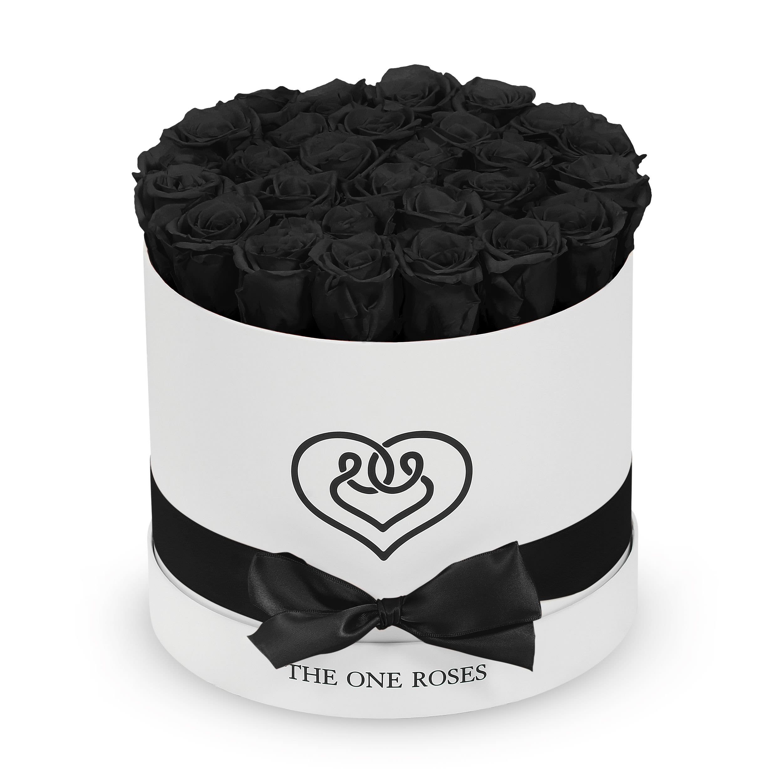 Round Flat | Classic White Box Onyx Black Round Flat | Classic White Box Onyx Black - The "runway round collection" consists of unique, real preserved roses in classic round handcrafted luxury soft touch box with a top. About 25-30 stems of the one long lasting (med size) preserved roses.  Durability: approx. 1-3 years.  Our roses, which are carefully sourced from the highest quality gardens in Ecuador, are made to represent the eternal yet ephemeral nature of Love itself. Our Roses are specially customized with essential oils to increase the fragrance.  Product Care: DO NOT Water the roses! AVOID direct exposure to sunlight. Keep the arrangement in a room-temperature environment. If dust collects after a few months, remove it lightly using a duster. DO NOT place anything onto the roses as they can crush and damage the roses. DO NOT remove the roses from the box; they are secure and happy there. DO NOT allow roses to have direct contact with light colored fabric or surfaces, as staining may occur. The lid is meant to stay on the side or bottom of the box. Be mindful when carrying the arrangement: it's a very delicate product!