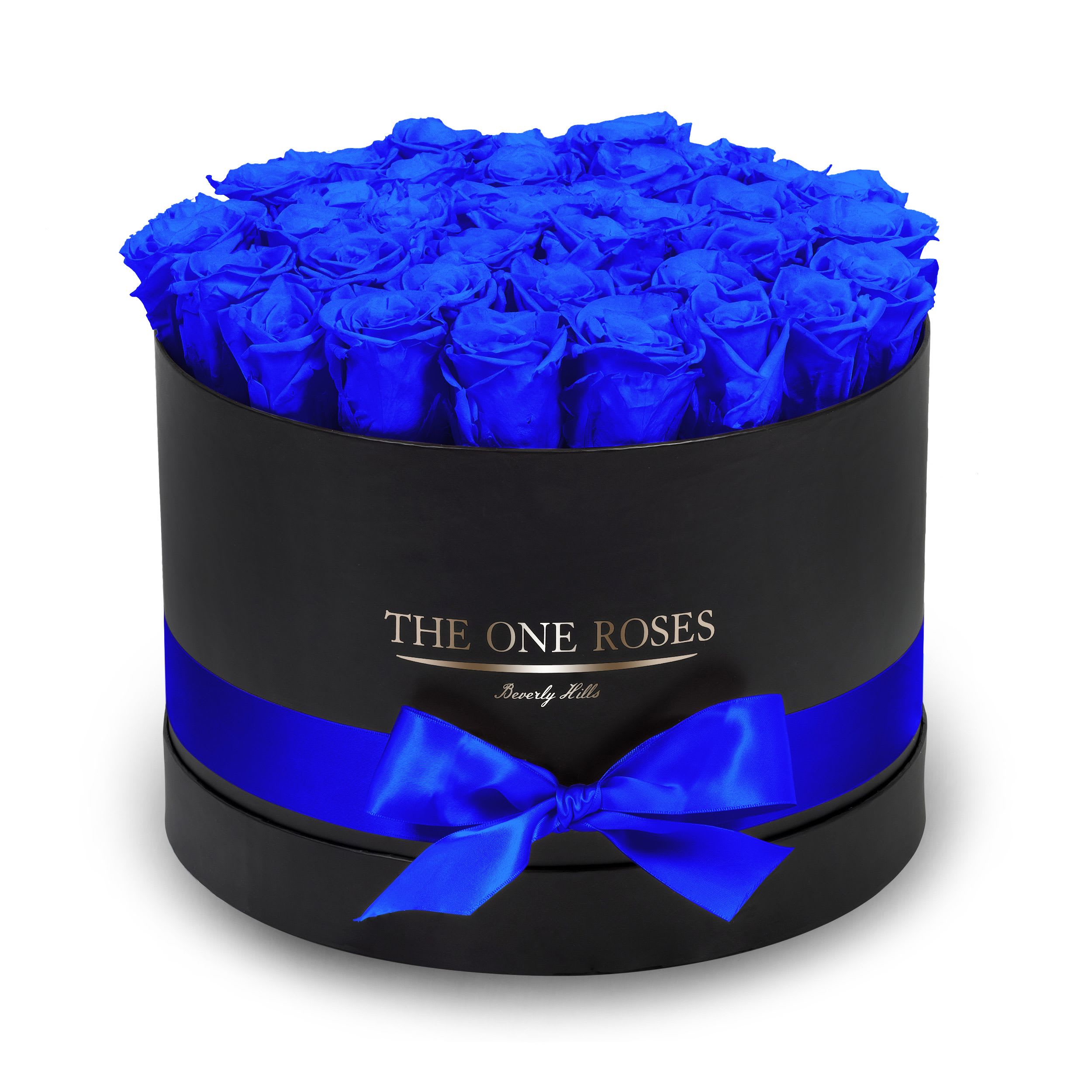 Round Flat | Premium Black Box Sapphire Blue Round Flat | Premium Black Box Sapphire Blue - The “Runway Round Collection”. consists of unique, real preserved roses in premium round handcrafted luxury soft touch box with a top. About 30-36 stems of The One long lasting (med size) preserved roses.  Durability: approx. 1-3 years.  Our roses, which are carefully sourced from the highest quality gardens in Ecuador, are made to represent the eternal yet ephemeral nature of Love itself. Our Roses are specially customized with essential oils to increase the fragrance.  Product Care: DO NOT Water the roses! AVOID direct exposure to sunlight. Keep the arrangement in a room-temperature environment. If dust collects after a few months, remove it lightly using a duster. DO NOT place anything onto the roses as they can crush and damage the roses. DO NOT remove the roses from the box; they are secure and happy there. DO NOT allow roses to have direct contact with light colored fabric or surfaces, as staining may occur. The lid is meant to stay on the side or bottom of the box. Be mindful when carrying the arrangement: it's a very delicate product!