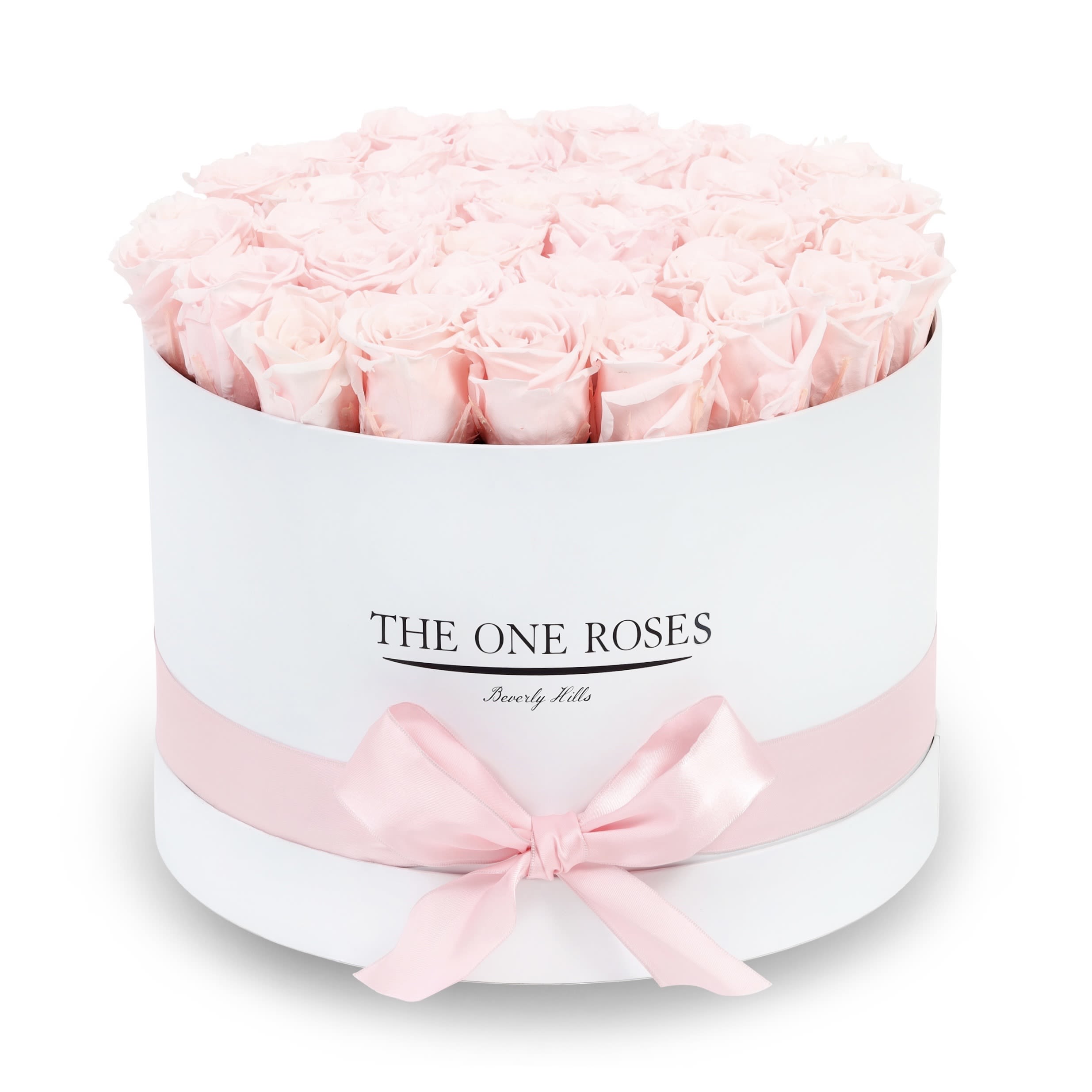 Round Flat | Premium White Box Fairy Tale Pink Round Flat | Premium White Box Fairy Tale Pink - The “Runway Round Collection”. consists of unique, real preserved roses in premium round handcrafted luxury soft touch box with a top. About 30-36 stems of The One long lasting (med size) preserved roses.  Durability: approx. 1-3 years.  Our roses, which are carefully sourced from the highest quality gardens in Ecuador, are made to represent the eternal yet ephemeral nature of Love itself. Our Roses are specially customized with essential oils to increase the fragrance.  Product Care: DO NOT Water the roses! AVOID direct exposure to sunlight. Keep the arrangement in a room-temperature environment. If dust collects after a few months, remove it lightly using a duster. DO NOT place anything onto the roses as they can crush and damage the roses. DO NOT remove the roses from the box; they are secure and happy there. DO NOT allow roses to have direct contact with light colored fabric or surfaces, as staining may occur. The lid is meant to stay on the side or bottom of the box. Be mindful when carrying the arrangement: it's a very delicate product!