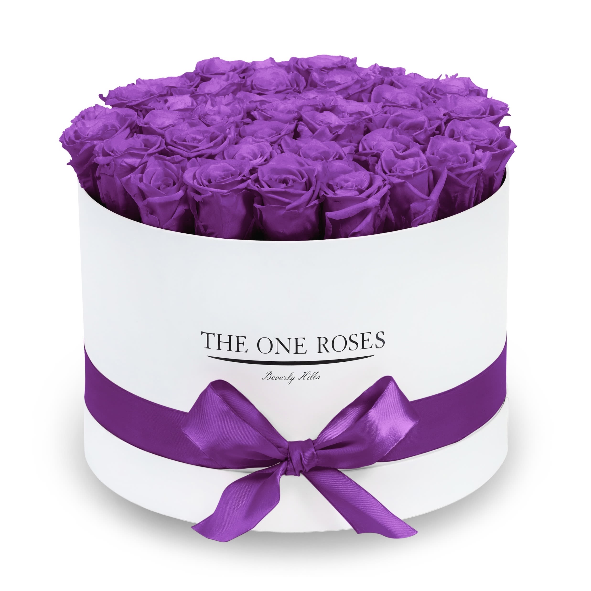 Round Flat | Premium White Box Purple Round Flat | Premium White Box Purple - The “Runway Round Collection”. consists of unique, real preserved roses in premium round handcrafted luxury soft touch box with a top. About 30-36 stems of The One long lasting (med size) preserved roses.  Durability: approx. 1-3 years.  Our roses, which are carefully sourced from the highest quality gardens in Ecuador, are made to represent the eternal yet ephemeral nature of Love itself. Our Roses are specially customized with essential oils to increase the fragrance.  Product Care: DO NOT Water the roses! AVOID direct exposure to sunlight. Keep the arrangement in a room-temperature environment. If dust collects after a few months, remove it lightly using a duster. DO NOT place anything onto the roses as they can crush and damage the roses. DO NOT remove the roses from the box; they are secure and happy there. DO NOT allow roses to have direct contact with light colored fabric or surfaces, as staining may occur. The lid is meant to stay on the side or bottom of the box. Be mindful when carrying the arrangement: it's a very delicate product!