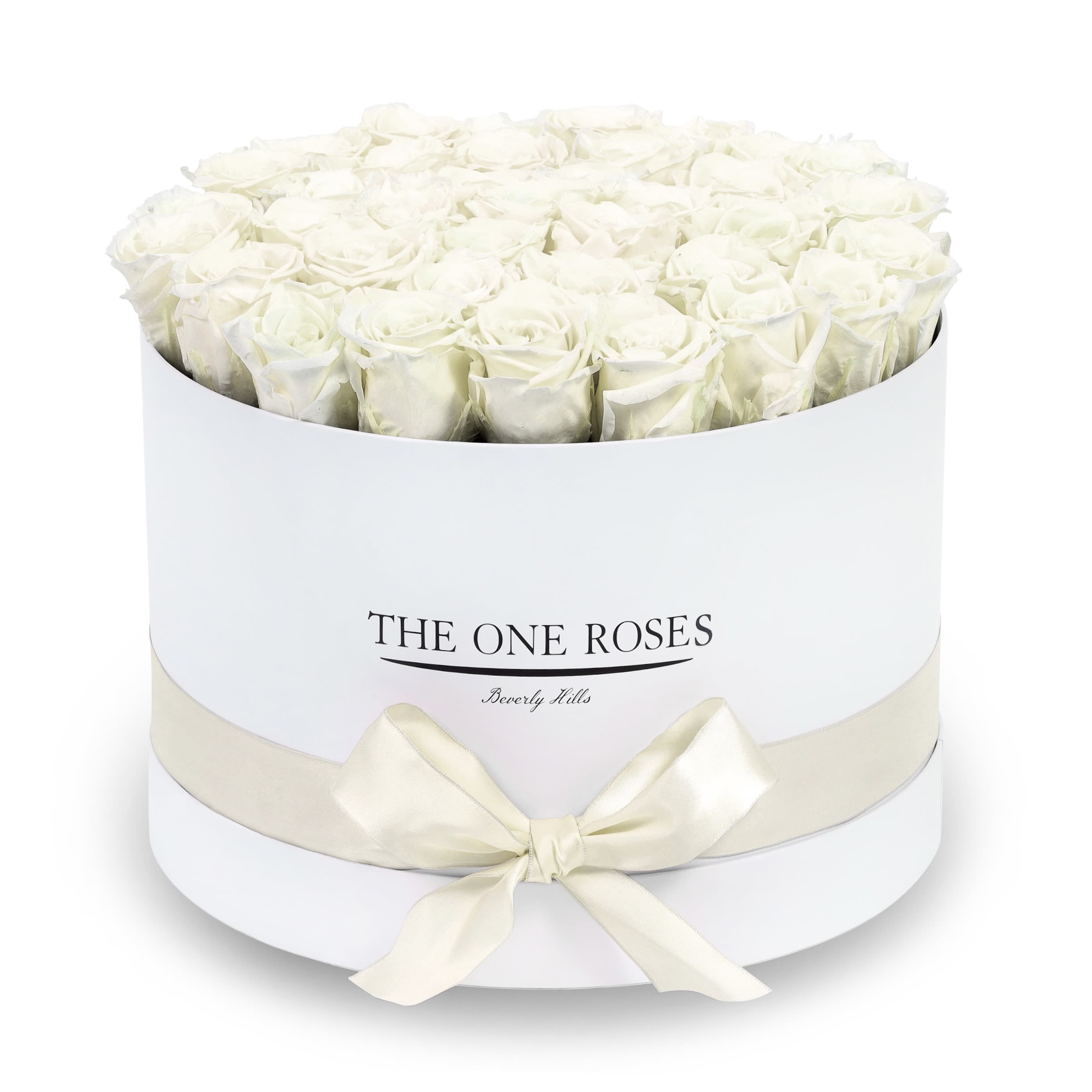 Round Flat | Premium White Box Pearl White Round Flat | Premium White Box Pearl White - The “Runway Round Collection”. consists of unique, real preserved roses in premium round handcrafted luxury soft touch box with a top. About 30-36 stems of The One long lasting (med size) preserved roses.  Durability: approx. 1-3 years.  Our roses, which are carefully sourced from the highest quality gardens in Ecuador, are made to represent the eternal yet ephemeral nature of Love itself. Our Roses are specially customized with essential oils to increase the fragrance.  Product Care: DO NOT Water the roses! AVOID direct exposure to sunlight. Keep the arrangement in a room-temperature environment. If dust collects after a few months, remove it lightly using a duster. DO NOT place anything onto the roses as they can crush and damage the roses. DO NOT remove the roses from the box; they are secure and happy there. DO NOT allow roses to have direct contact with light colored fabric or surfaces, as staining may occur. The lid is meant to stay on the side or bottom of the box. Be mindful when carrying the arrangement: it's a very delicate product!
