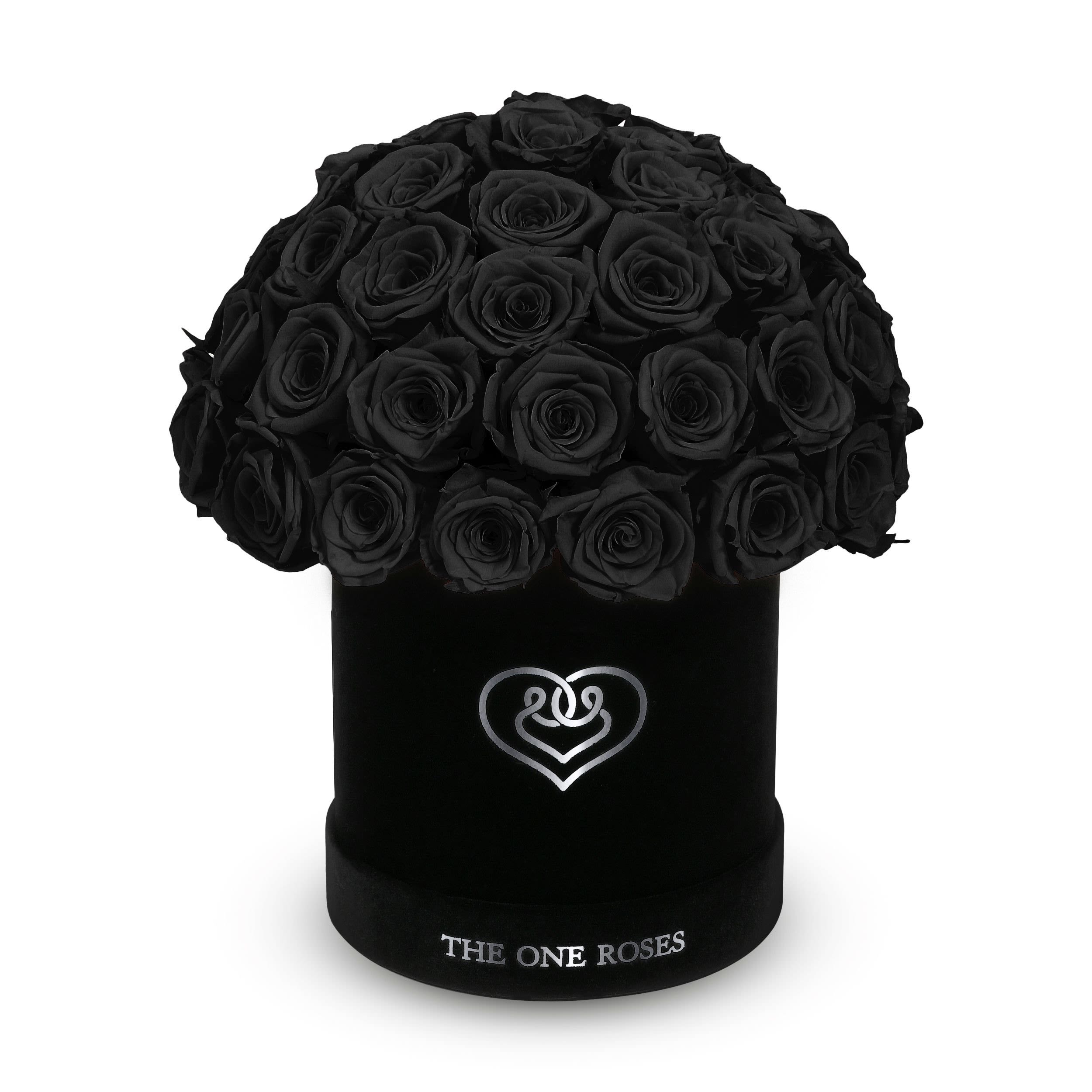Suede Dome | Basic Black Box Onyx Black Suede Dome | Basic Black Box Onyx Black - The One Roses “Suede Collection“ consists of unique, real preserved roses in basic round handcrafted luxury black suede box with a top.  With about 50 stems of The One long lasting (med size) real preserved roses.  Durability: approx. 1-3 years.  Product Dimension: 6″× 6″ / ABOUT 50 ROSES  Our roses, which are carefully sourced from the highest quality gardens in Ecuador, are made to represent the eternal yet ephemeral nature of Love itself. Our Roses are specially customized with essential oils to increase the fragrance.  Product Care: DO NOT Water the roses! AVOID direct exposure to sunlight. Keep the arrangement in a room-temperature environment. If dust collects after a few months, remove it lightly using a duster. DO NOT place anything onto the roses as they can crush and damage the roses. DO NOT remove the roses from the box; they are secure and happy there. DO NOT allow roses to have direct contact with light colored fabric or surfaces, as staining may occur. The lid is meant to stay on the side or bottom of the box. Be mindful when carrying the arrangement: it's a very delicate product!