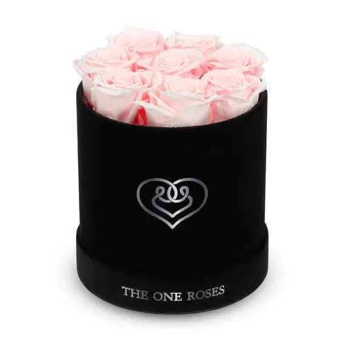 Suede Flat | Basic Black Box Fairy Tale Pink Suede Flat | Basic Black Box Fairy Tale Pink - Our Black-Suede Basic Box with The One Eternity Roses comes in a luxury suede hand crafted box. About 8 stems of The One long lasting (med size) preserved real roses.   Durability: approx. 1-3 years.   Product Dimension: 6″ × 6″ / 8 ROSES   Our roses, which are carefully sourced from the highest quality gardens in Ecuador, are made to represent the eternal yet ephemeral nature of Love itself. Our Roses are specially customized with essential oils to increase the fragrance.   Product Care: DO NOT Water the roses! AVOID direct exposure to sunlight. Keep the arrangement in a room-temperature environment. If dust collects after a few months, remove it lightly using a duster. DO NOT place anything onto the roses as they can crush and damage the roses. DO NOT remove the roses from the box; they are secure and happy there. DO NOT allow roses to have direct contact with light colored fabric or surfaces, as staining may occur. The lid is meant to stay on the side or bottom of the box. Be mindful when carrying the arrangement: it's a very delicate product!