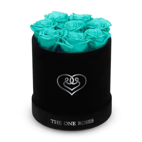 Suede Flat | Basic Black Box fairy Teal Blue Suede Flat | Basic Black Box fairy Teal Blue - Our Black-Suede Basic Box with The One Eternity Roses comes in a luxury suede hand crafted box. About 8 stems of The One long lasting (med size) preserved real roses.   Durability: approx. 1-3 years.   Product Dimension: 6″ × 6″ / 8 ROSES   Our roses, which are carefully sourced from the highest quality gardens in Ecuador, are made to represent the eternal yet ephemeral nature of Love itself. Our Roses are specially customized with essential oils to increase the fragrance.   Product Care: DO NOT Water the roses! AVOID direct exposure to sunlight. Keep the arrangement in a room-temperature environment. If dust collects after a few months, remove it lightly using a duster. DO NOT place anything onto the roses as they can crush and damage the roses. DO NOT remove the roses from the box; they are secure and happy there. DO NOT allow roses to have direct contact with light colored fabric or surfaces, as staining may occur. The lid is meant to stay on the side or bottom of the box. Be mindful when carrying the arrangement: it's a very delicate product!