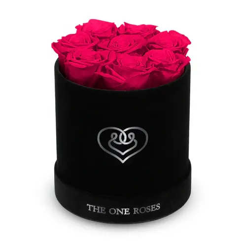 Suede Flat | Basic Black Box Hot Pink Suede Flat | Basic Black Box Hot Pink - Our Black-Suede Basic Box with The One Eternity Roses comes in a luxury suede hand crafted box. About 8 stems of The One long lasting (med size) preserved real roses.   Durability: approx. 1-3 years.   Product Dimension: 6″ × 6″ / 8 ROSES   Our roses, which are carefully sourced from the highest quality gardens in Ecuador, are made to represent the eternal yet ephemeral nature of Love itself. Our Roses are specially customized with essential oils to increase the fragrance.   Product Care: DO NOT Water the roses! AVOID direct exposure to sunlight. Keep the arrangement in a room-temperature environment. If dust collects after a few months, remove it lightly using a duster. DO NOT place anything onto the roses as they can crush and damage the roses. DO NOT remove the roses from the box; they are secure and happy there. DO NOT allow roses to have direct contact with light colored fabric or surfaces, as staining may occur. The lid is meant to stay on the side or bottom of the box. Be mindful when carrying the arrangement: it's a very delicate product!
