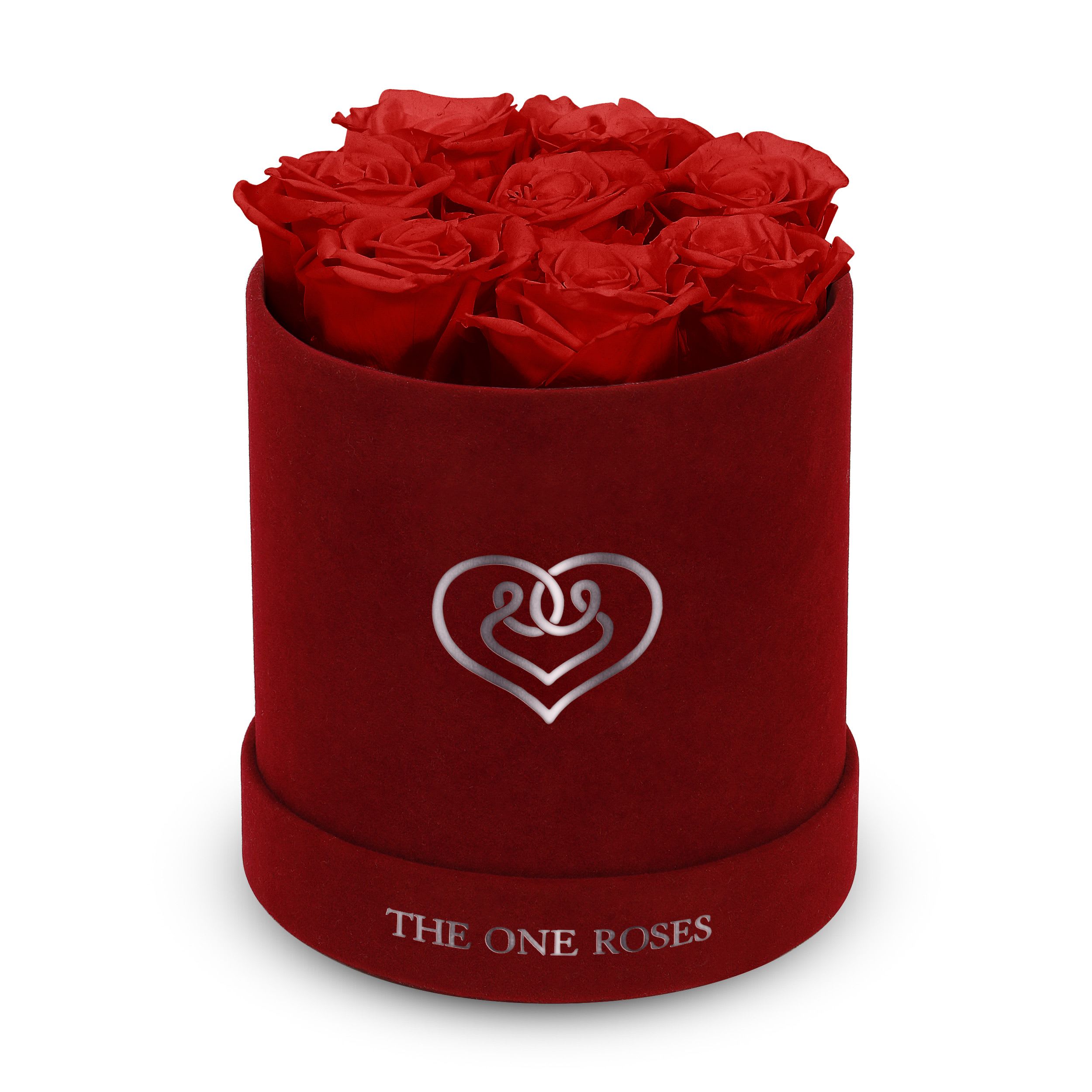 Suede Flat | Basic Burgundy Box Crimson Red Suede Flat | Basic Burgundy Box Crimson Red - Our Burgundy-Suede Basic Box with The One Eternity Roses comes in a luxury suede hand crafted box. About 8 stems of The One long lasting (med size) preserved real roses.   Durability: approx. 1-3 years.   Product Dimension: 6″ × 6″ / 8 ROSES   Our roses, which are carefully sourced from the highest quality gardens in Ecuador, are made to represent the eternal yet ephemeral nature of Love itself. Our Roses are specially customized with essential oils to increase the fragrance.   Product Care: DO NOT Water the roses! AVOID direct exposure to sunlight. Keep the arrangement in a room-temperature environment. If dust collects after a few months, remove it lightly using a duster. DO NOT place anything onto the roses as they can crush and damage the roses. DO NOT remove the roses from the box; they are secure and happy there. DO NOT allow roses to have direct contact with light colored fabric or surfaces, as staining may occur. The lid is meant to stay on the side or bottom of the box. Be mindful when carrying the arrangement: it's a very delicate product!