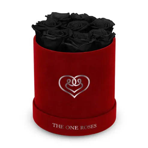 Suede Flat | Basic Burgundy Box Onyx Black Suede Flat | Basic Burgundy Box Onyx Black - Our Burgundy-Suede Basic Box with The One Eternity Roses comes in a luxury suede hand crafted box. About 8 stems of The One long lasting (med size) preserved real roses.   Durability: approx. 1-3 years.   Product Dimension: 6″ × 6″ / 8 ROSES   Our roses, which are carefully sourced from the highest quality gardens in Ecuador, are made to represent the eternal yet ephemeral nature of Love itself. Our Roses are specially customized with essential oils to increase the fragrance.   Product Care: DO NOT Water the roses! AVOID direct exposure to sunlight. Keep the arrangement in a room-temperature environment. If dust collects after a few months, remove it lightly using a duster. DO NOT place anything onto the roses as they can crush and damage the roses. DO NOT remove the roses from the box; they are secure and happy there. DO NOT allow roses to have direct contact with light colored fabric or surfaces, as staining may occur. The lid is meant to stay on the side or bottom of the box. Be mindful when carrying the arrangement: it's a very delicate product!