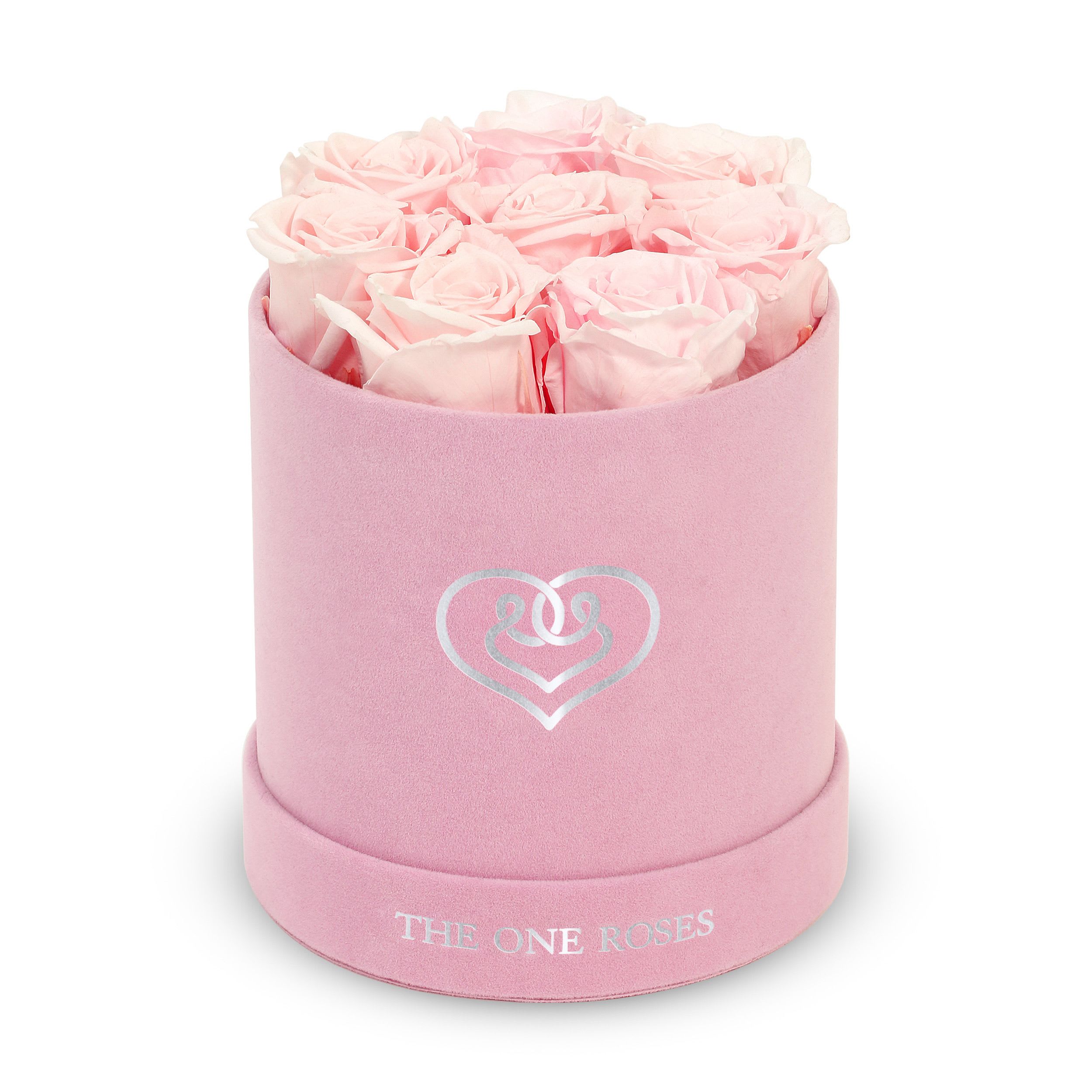 Suede Flat | Basic Pink Box Fairy Tale Pink Suede Flat | Basic Pink Box Fairy Tale Pink - Our Pink-Suede Basic Box with The One Eternity Roses comes in a luxury suede hand crafted box. About 8 stems of The One long lasting (med size) preserved real roses.   Durability: approx. 1-3 years.   Product Dimension: 6″ × 6″ / 8 ROSES   Our roses, which are carefully sourced from the highest quality gardens in Ecuador, are made to represent the eternal yet ephemeral nature of Love itself. Our Roses are specially customized with essential oils to increase the fragrance.   Product Care: DO NOT Water the roses! AVOID direct exposure to sunlight. Keep the arrangement in a room-temperature environment. If dust collects after a few months, remove it lightly using a duster. DO NOT place anything onto the roses as they can crush and damage the roses. DO NOT remove the roses from the box; they are secure and happy there. DO NOT allow roses to have direct contact with light colored fabric or surfaces, as staining may occur. The lid is meant to stay on the side or bottom of the box. Be mindful when carrying the arrangement: it's a very delicate product!
