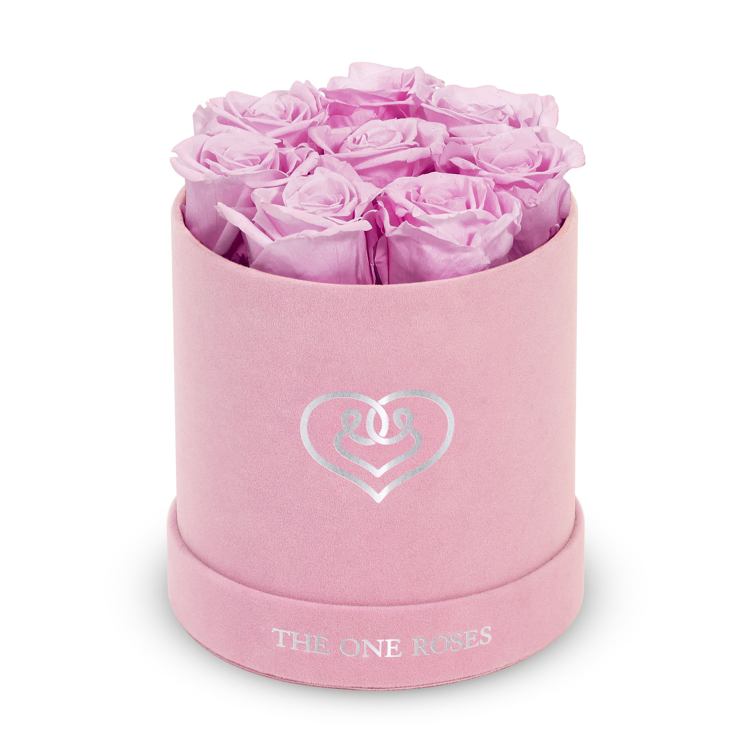 Suede Flat | Basic Pink Box Lilac Suede Flat | Basic Pink Box Lilac - Our Pink-Suede Basic Box with The One Eternity Roses comes in a luxury suede hand crafted box. About 8 stems of The One long lasting (med size) preserved real roses.   Durability: approx. 1-3 years.   Product Dimension: 6″ × 6″ / 8 ROSES   Our roses, which are carefully sourced from the highest quality gardens in Ecuador, are made to represent the eternal yet ephemeral nature of Love itself. Our Roses are specially customized with essential oils to increase the fragrance.   Product Care: DO NOT Water the roses! AVOID direct exposure to sunlight. Keep the arrangement in a room-temperature environment. If dust collects after a few months, remove it lightly using a duster. DO NOT place anything onto the roses as they can crush and damage the roses. DO NOT remove the roses from the box; they are secure and happy there. DO NOT allow roses to have direct contact with light colored fabric or surfaces, as staining may occur. The lid is meant to stay on the side or bottom of the box. Be mindful when carrying the arrangement: it's a very delicate product!