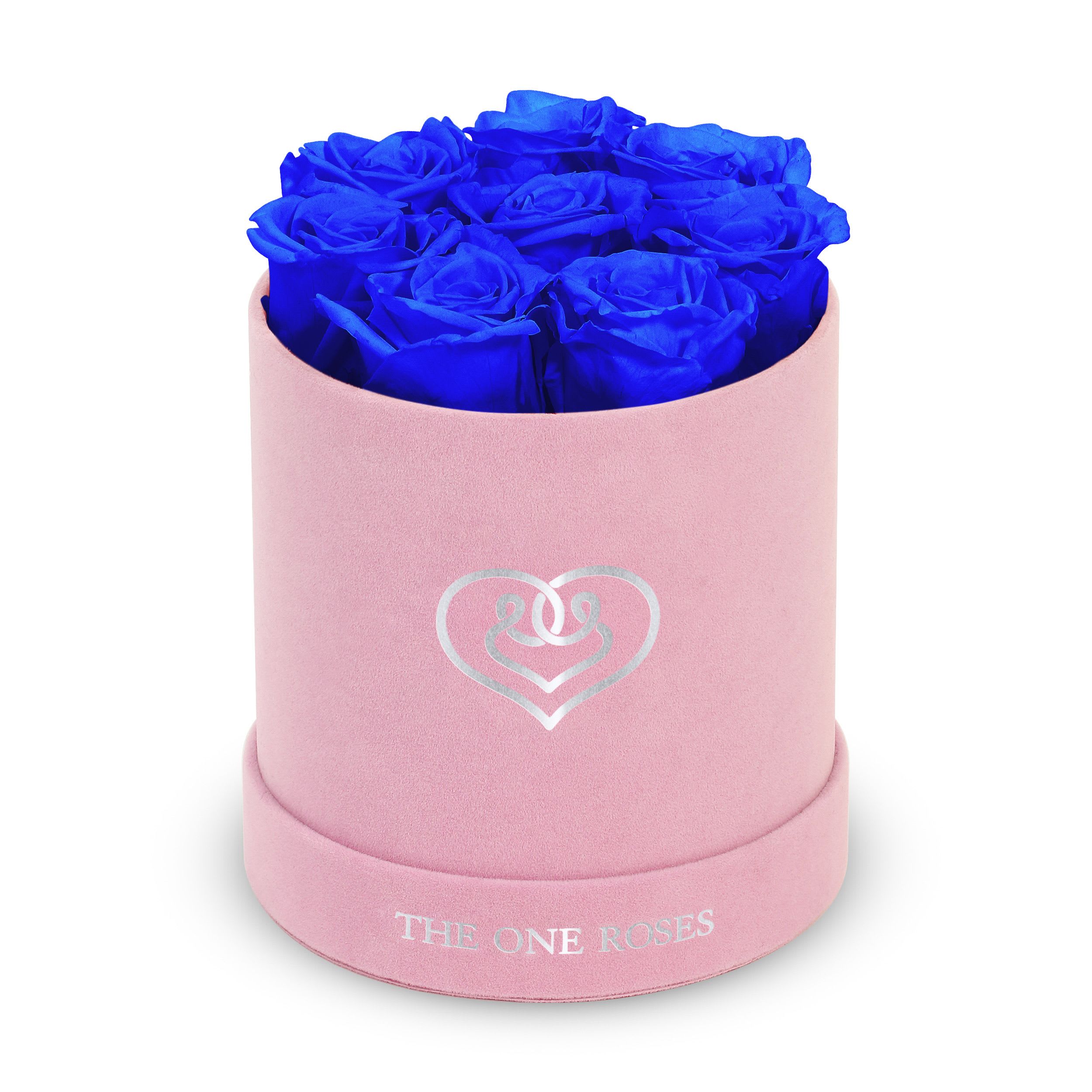 Suede Flat | Basic Pink Box Sapphire Blue Suede Flat | Basic Pink Box Sapphire Blue - Our Pink-Suede Basic Box with The One Eternity Roses comes in a luxury suede hand crafted box. About 8 stems of The One long lasting (med size) preserved real roses.   Durability: approx. 1-3 years.   Product Dimension: 6″ × 6″ / 8 ROSES   Our roses, which are carefully sourced from the highest quality gardens in Ecuador, are made to represent the eternal yet ephemeral nature of Love itself. Our Roses are specially customized with essential oils to increase the fragrance.   Product Care: DO NOT Water the roses! AVOID direct exposure to sunlight. Keep the arrangement in a room-temperature environment. If dust collects after a few months, remove it lightly using a duster. DO NOT place anything onto the roses as they can crush and damage the roses. DO NOT remove the roses from the box; they are secure and happy there. DO NOT allow roses to have direct contact with light colored fabric or surfaces, as staining may occur. The lid is meant to stay on the side or bottom of the box. Be mindful when carrying the arrangement: it's a very delicate product!