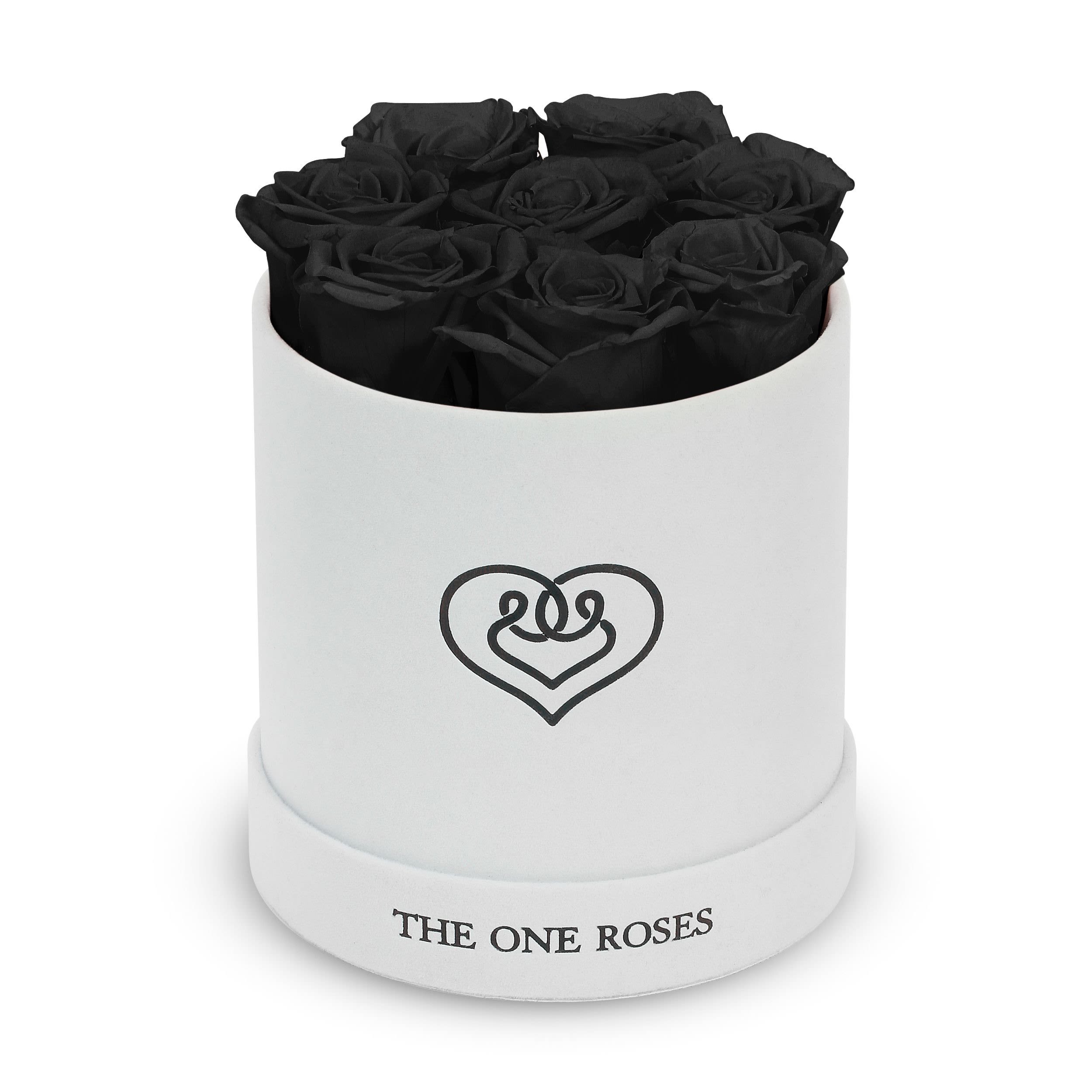 Suede Flat | Basic White Box Onyx Black Suede Flat | Basic White Box Onyx Black - Our White-Suede Basic Box with The One Eternity Roses comes in a luxury suede hand crafted box. About 8 stems of The One long lasting (med size) preserved real roses.  Durability: approx. 1-3 years.  Product Dimension: 6″ × 6″ / 8 ROSES  Our roses, which are carefully sourced from the highest quality gardens in Ecuador, are made to represent the eternal yet ephemeral nature of Love itself. Our Roses are specially customized with essential oils to increase the fragrance.  Product Care: DO NOT Water the roses! AVOID direct exposure to sunlight. Keep the arrangement in a room-temperature environment. If dust collects after a few months, remove it lightly using a duster. DO NOT place anything onto the roses as they can crush and damage the roses. DO NOT remove the roses from the box; they are secure and happy there. DO NOT allow roses to have direct contact with light colored fabric or surfaces, as staining may occur. The lid is meant to stay on the side or bottom of the box. Be mindful when carrying the arrangement: it's a very delicate product!