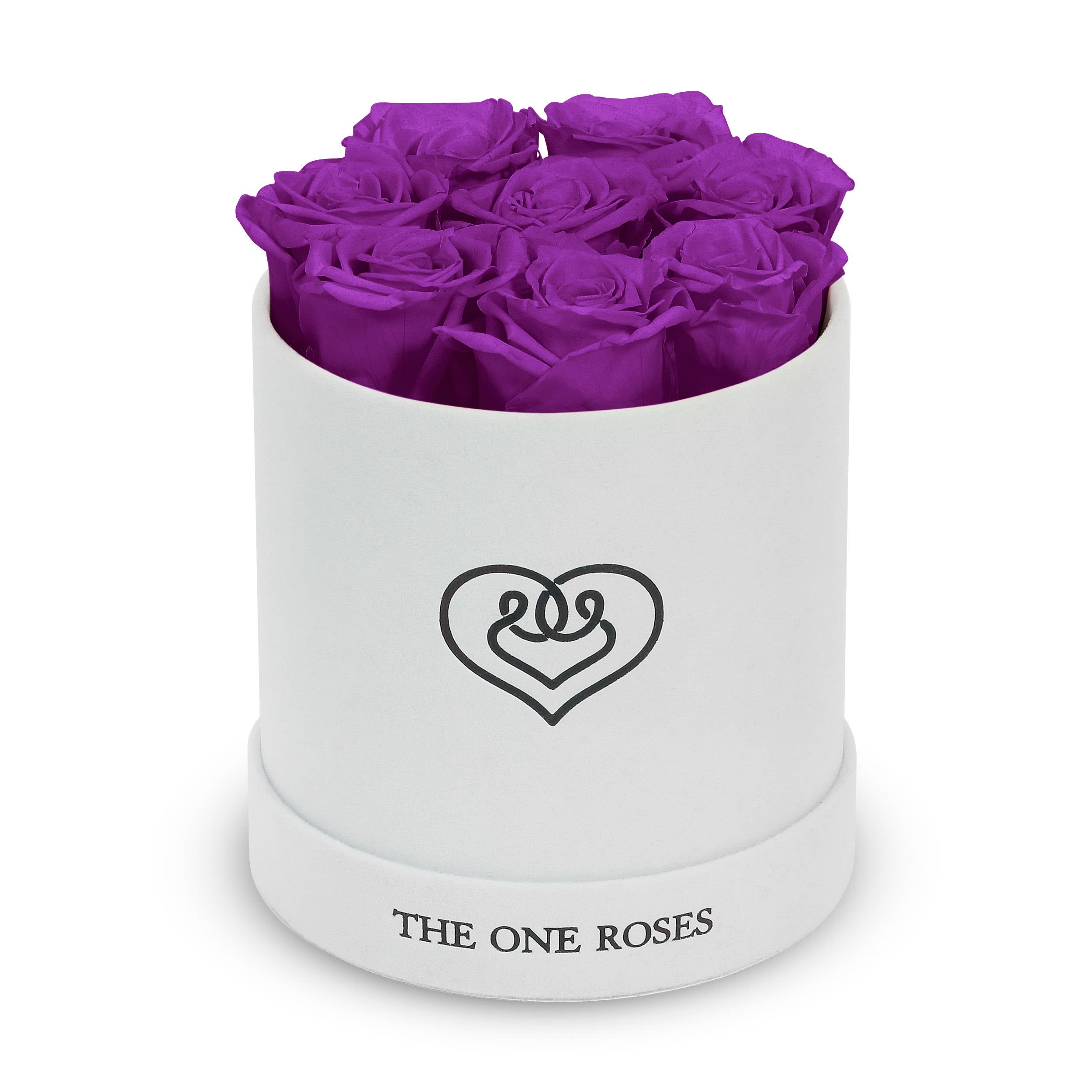 Suede Flat | Basic White Box Purple Suede Flat | Basic White Box Purple - Our White-Suede Basic Box with The One Eternity Roses comes in a luxury suede hand crafted box. About 8 stems of The One long lasting (med size) preserved real roses.  Durability: approx. 1-3 years.  Product Dimension: 6″ × 6″ / 8 ROSES  Our roses, which are carefully sourced from the highest quality gardens in Ecuador, are made to represent the eternal yet ephemeral nature of Love itself. Our Roses are specially customized with essential oils to increase the fragrance.  Product Care: DO NOT Water the roses! AVOID direct exposure to sunlight. Keep the arrangement in a room-temperature environment. If dust collects after a few months, remove it lightly using a duster. DO NOT place anything onto the roses as they can crush and damage the roses. DO NOT remove the roses from the box; they are secure and happy there. DO NOT allow roses to have direct contact with light colored fabric or surfaces, as staining may occur. The lid is meant to stay on the side or bottom of the box. Be mindful when carrying the arrangement: it's a very delicate product!