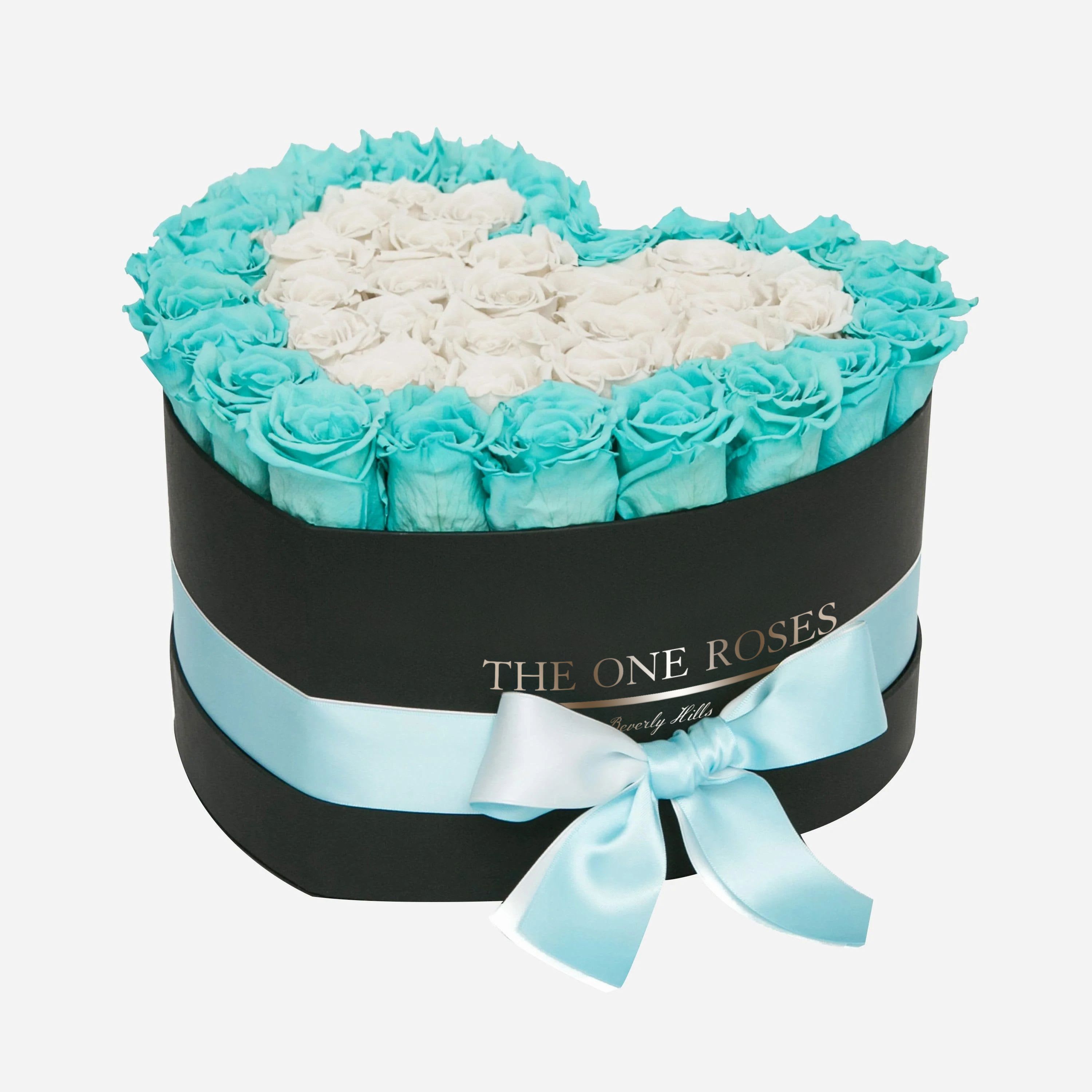 Teal Blue and White Roses | Black "Love" Box with Teal Blue Ribbon Teal Blue and White Roses | Black "Love" Box with Teal Blue Ribbon - The "heart box collection" consists of unique, real preserved roses handcrafted, soft, and elegant heart box with a top. Luxury arrangement of about 31 stems of the one long lasting (med size) real preserved roses.  Durability: approx. 1-3 years.  Our roses, which are carefully sourced from the highest quality gardens in Ecuador, are made to represent the eternal yet ephemeral nature of Love itself. Our Roses are specially customized with essential oils to increase the fragrance.