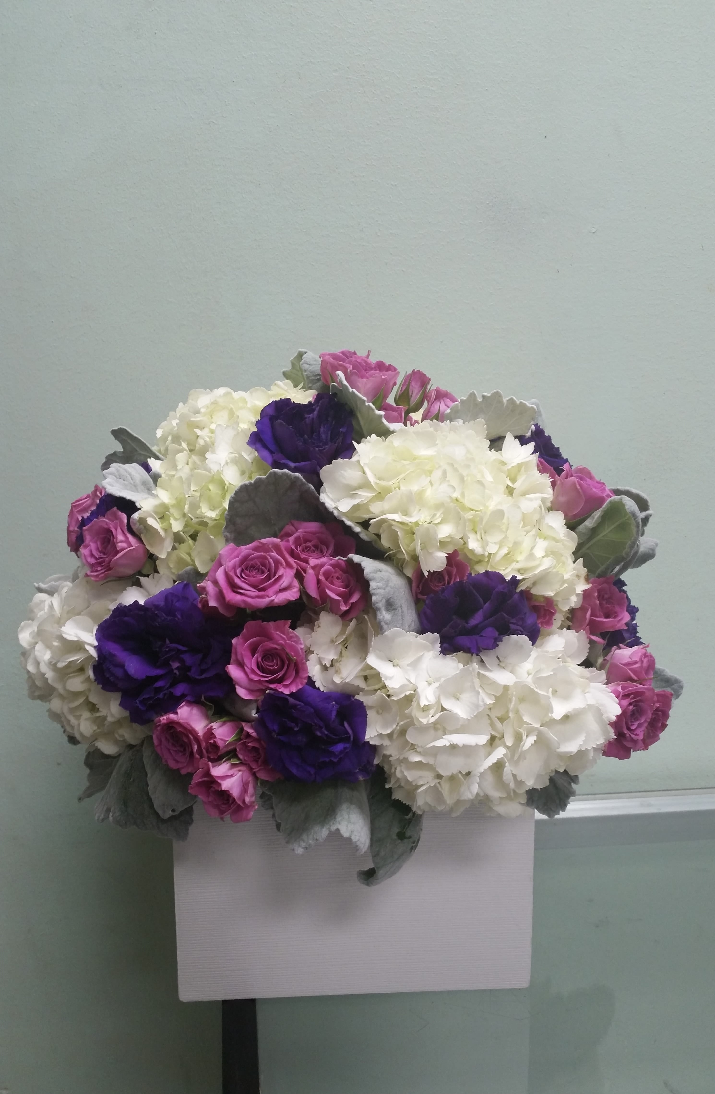 Vibrant Trio Vibrant Trio - Box arrangement with hydrangeas, spray roses, and lisianthus.