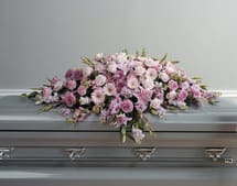 PURE DEVOTION- ON SALE WAS $390 - ALL PINK TONES, FEATURING STARGAZERS, GERBERS, ROSES AND SNAPDRAGONS. THIS IS A FULL CASKET SPRAY. A PRICELESS SPECIAL SHOW OF SYMPATHY.
