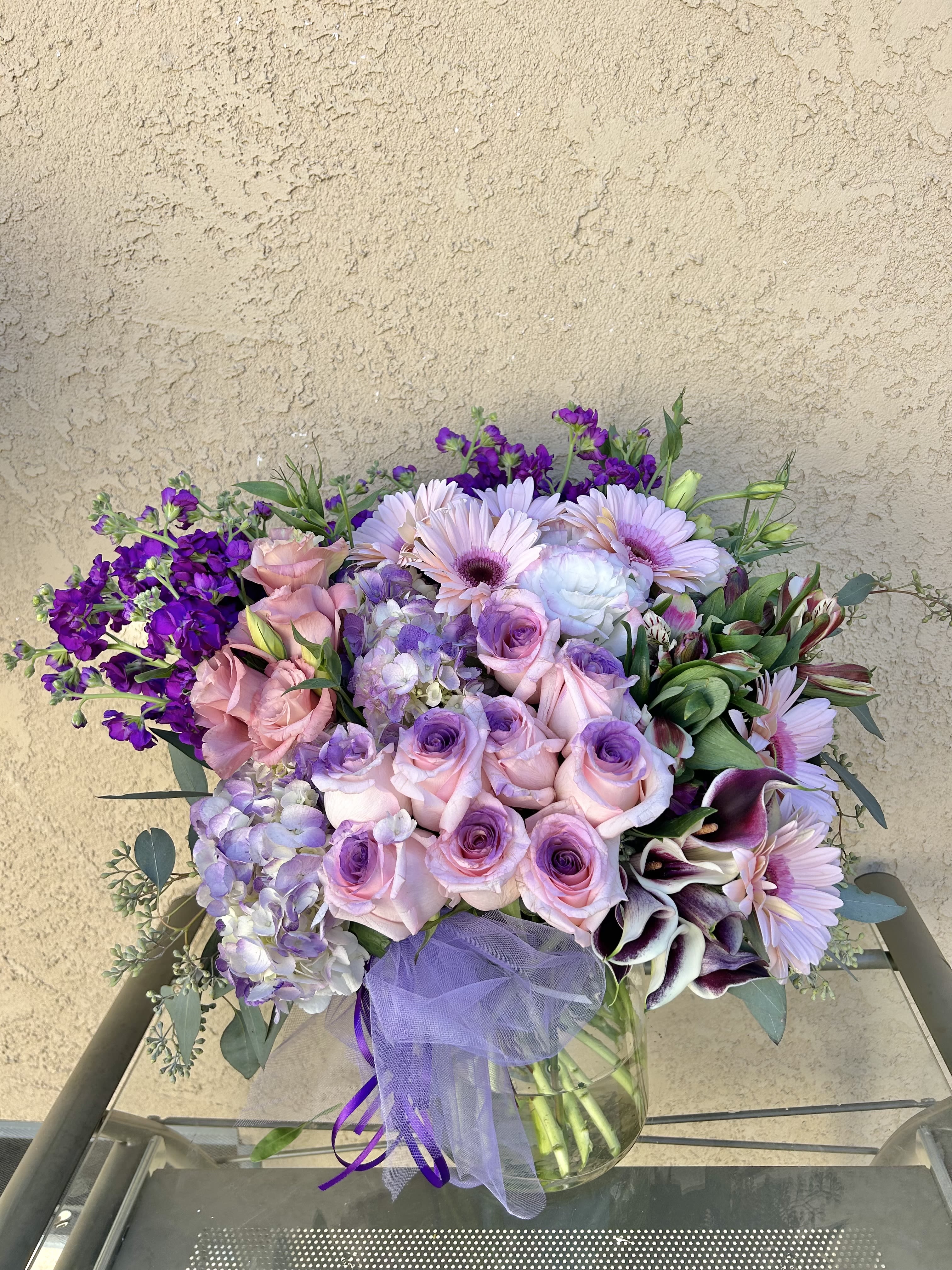 Eternal Summer - Beautiful purple and white arrangement featuring roses, stock, hydrangeas, calla lillies, and green accents.