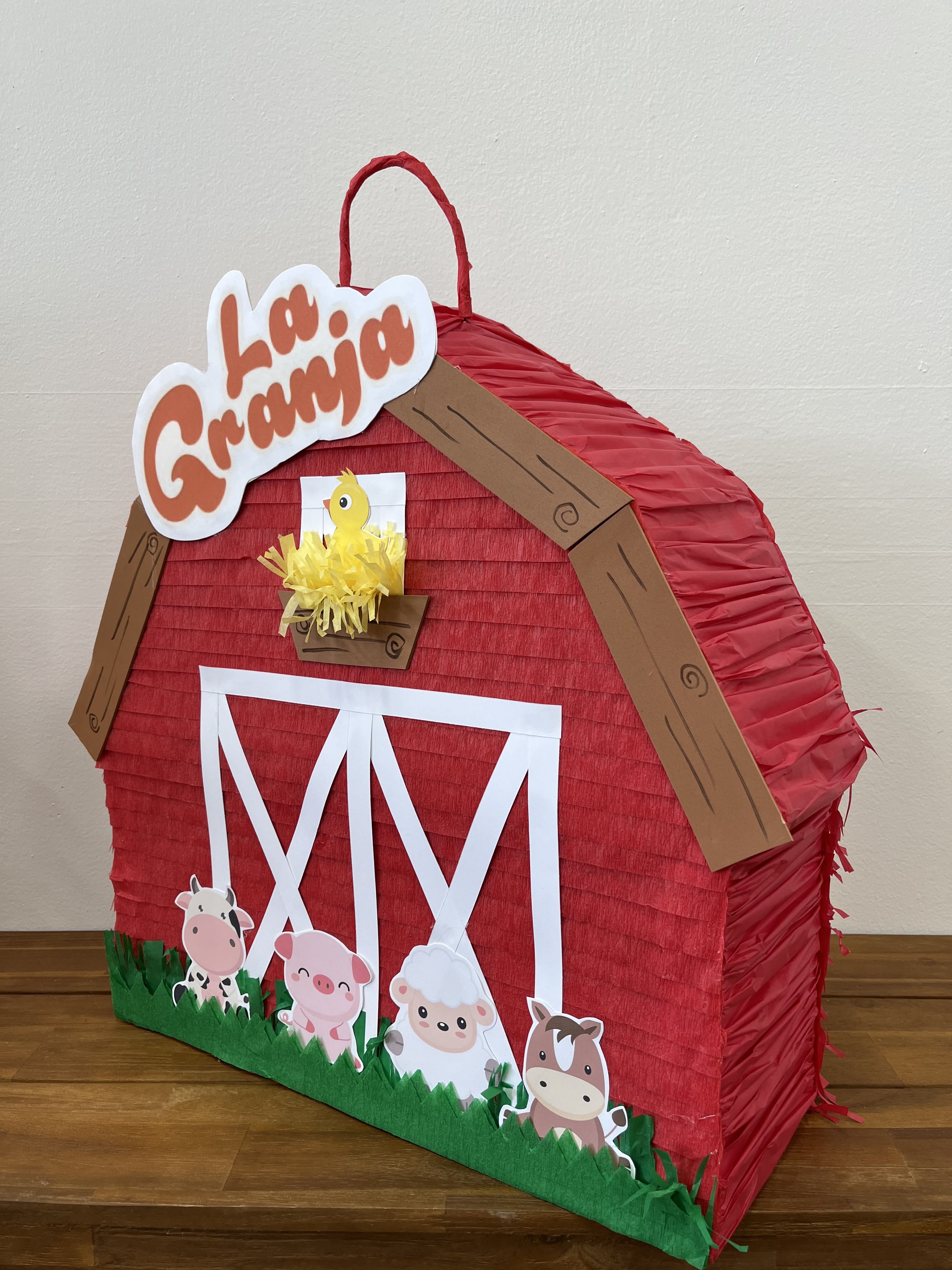 La Granja Piñata La Granja Piñata - Bring the charm of the countryside to your next party with our "La Granja Piñata." Featuring a vibrant red barnyard surrounded by an assortment of adorable barn animals, this piñata adds a playful touch to any celebration. Perfect for farm-themed events, it promises hours of fun as guests take turns trying to break open this delightful barn to reveal a trove of treats and surprises inside. It's the perfect centerpiece for a festive and memorable occasion!