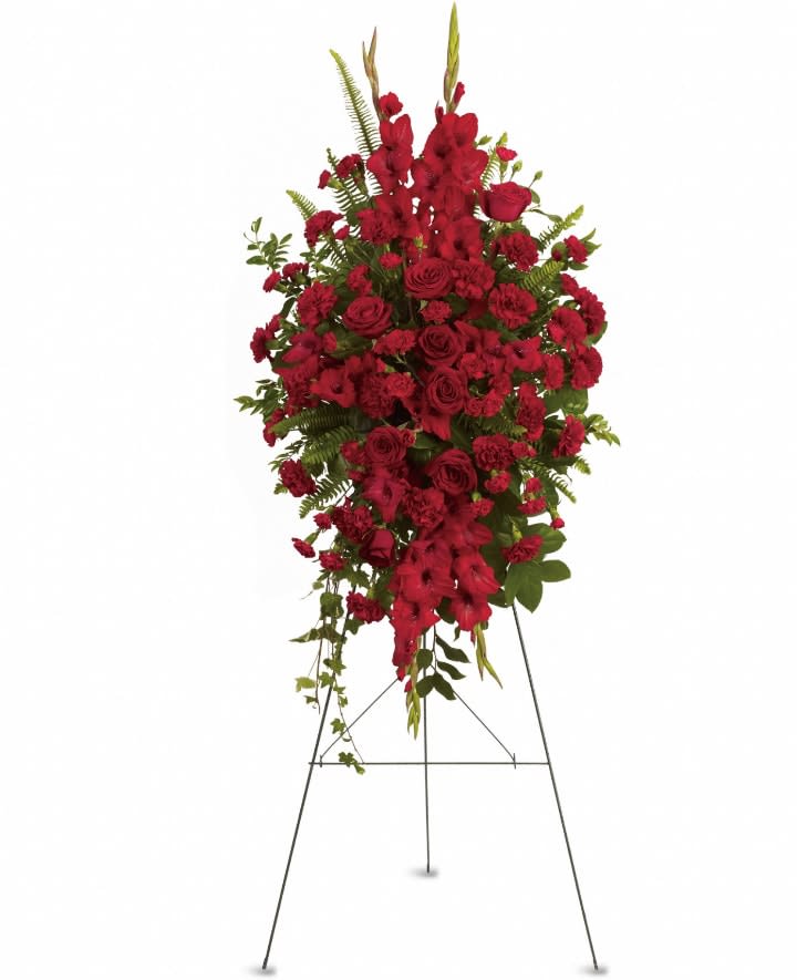 Deep in Our Hearts Spray - Express your heartfelt sympathies with this magnificent spray of all-red floral favorites. It is a beautiful and vibrant way to help ease the pain of loss. The radiant arrangement includes red roses, red gladioli, red carnations and red miniature carnations, accented with assorted greenery. Orientation: One-Sided