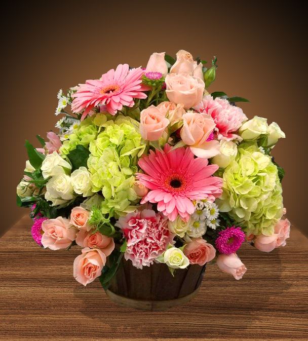 Pastel Basket of Cheer - Beautiful mix of  roses, gerbera daisies and hydrangeas arranged in a wicker basket.