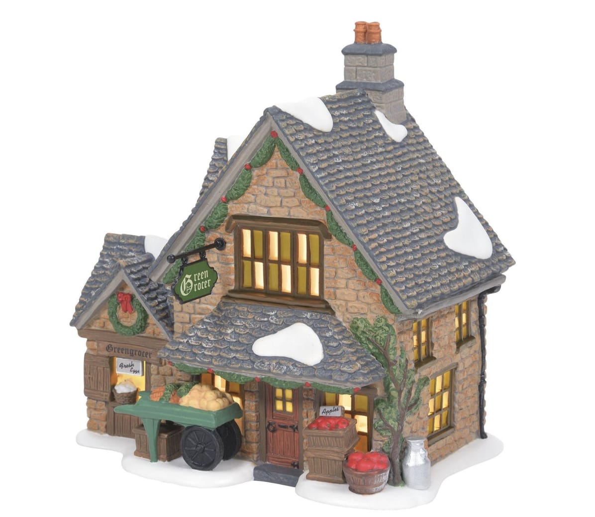 Cotswald Greengrocer - Bring the charm of the English countryside to your holiday village with the Cotswold Greengrocer, a delightful lighted building from the Dickens Village collection. Inspired by the picturesque Cotswolds region, known for its rolling hills and quaint architecture, this hand-painted, handcrafted porcelain building captures the timeless appeal of a traditional greengrocer—a shop specializing in fresh fruits and vegetables. Featuring realistic details like cobblestone walls, festive greenery, and a warm interior glow, this piece is perfect for adding an authentic British touch to your collection.