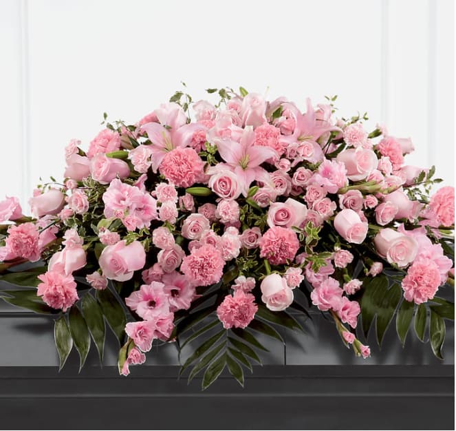 Garden of Comfort Casket Spray (Standard) Garden of Comfort Casket Spray (Standard) - Honor a loved one who was sweet, compassionate and charming with our Garden of Comfort Casket Spray. It is crafted with care and composed of a refined array of pink lilies, gladiolus, roses, carnations and accents of luscious greens. This arrangement is a touching tribute that beautifully expresses your love. DETAILS 48"h x 38"w