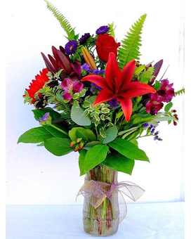 Fall Sunset - Beautiful and rich colors of roses, sunflowers, Asiatic lilies, alstromeria, safari sunset and other seasonal flowers and assorted greenery in a glass vase. (Certain flowers and container may be varied and subject to availability).
