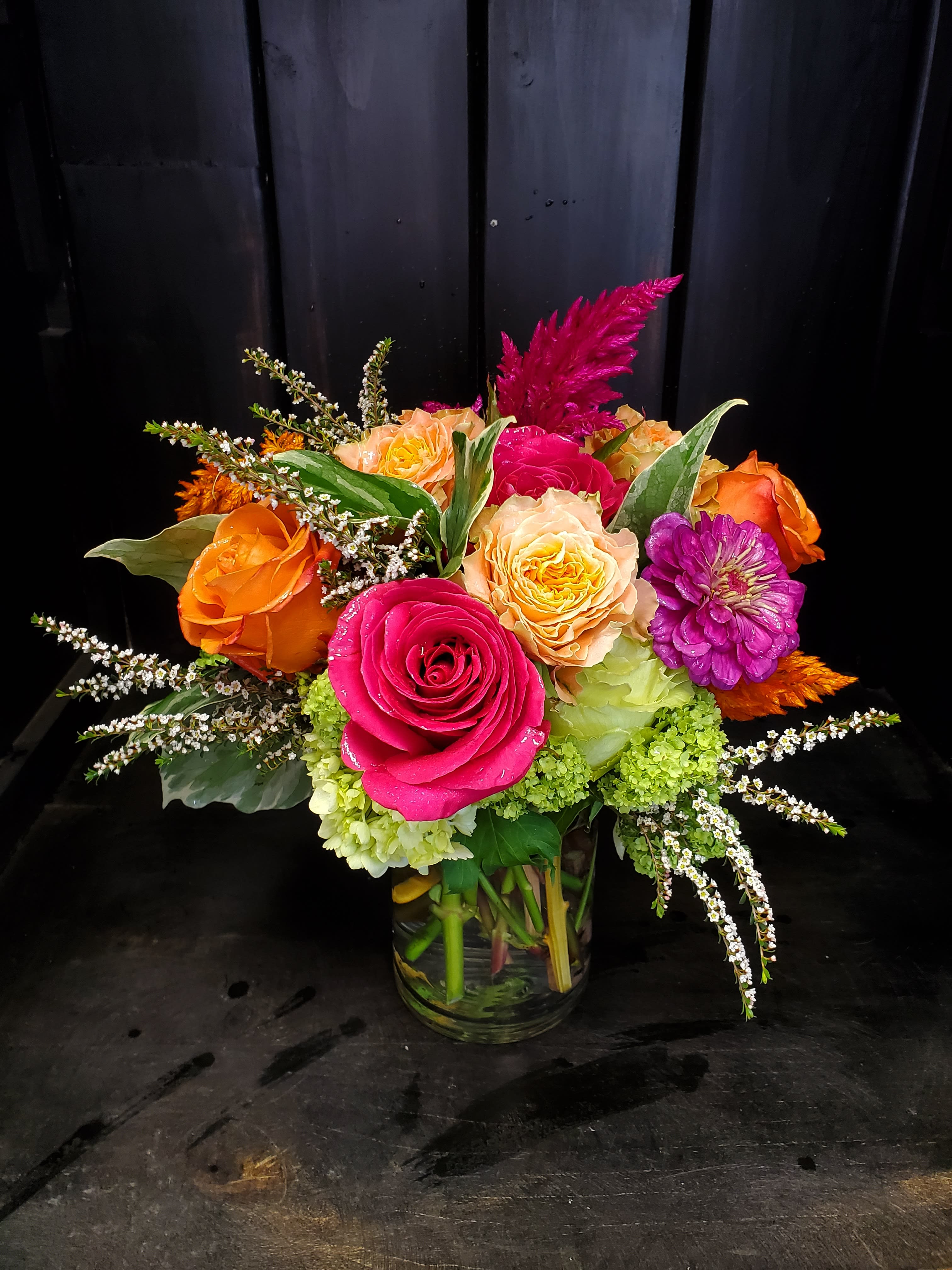 Happy Day Bouquet Happy Day Bouquet - This cutie is perfect for that special someone that has a love for the freshest roses. Designed in a clear glass vase this bouquet offers all the hot colors the season has to offer! Get it while it's hot!