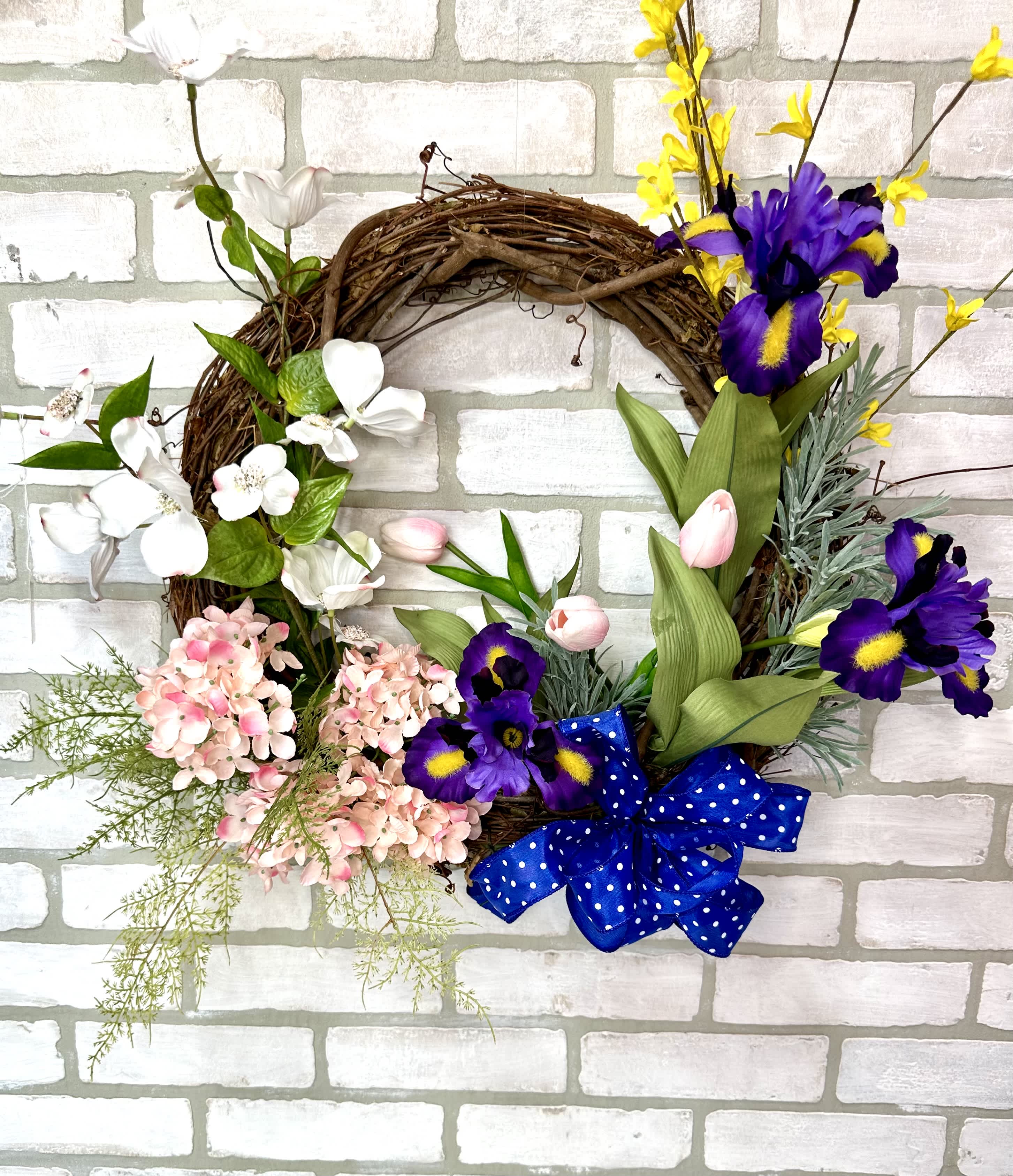 Hydrangea &amp; Iris Silk Door Wreath  - A grapevine wreath arranged with artificial iris, hydrangea, tulips, moth orchids, peavine florals, and a blue polka dot bow.   ***26 inches long x 24 inches wide**