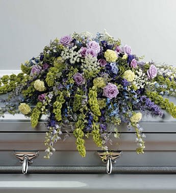 Lavender Tribute Casket Spray Lavender Tribute Casket Spray - Like a heartfelt embrace, this beautiful casket spray delivers comfort and love in an extraordinary way. A wonderful array of lavender and white, Green flowers with just the right amount of greenery is a lovely way to pay tribute to someone who will always be with you in heart, mind and spirit.