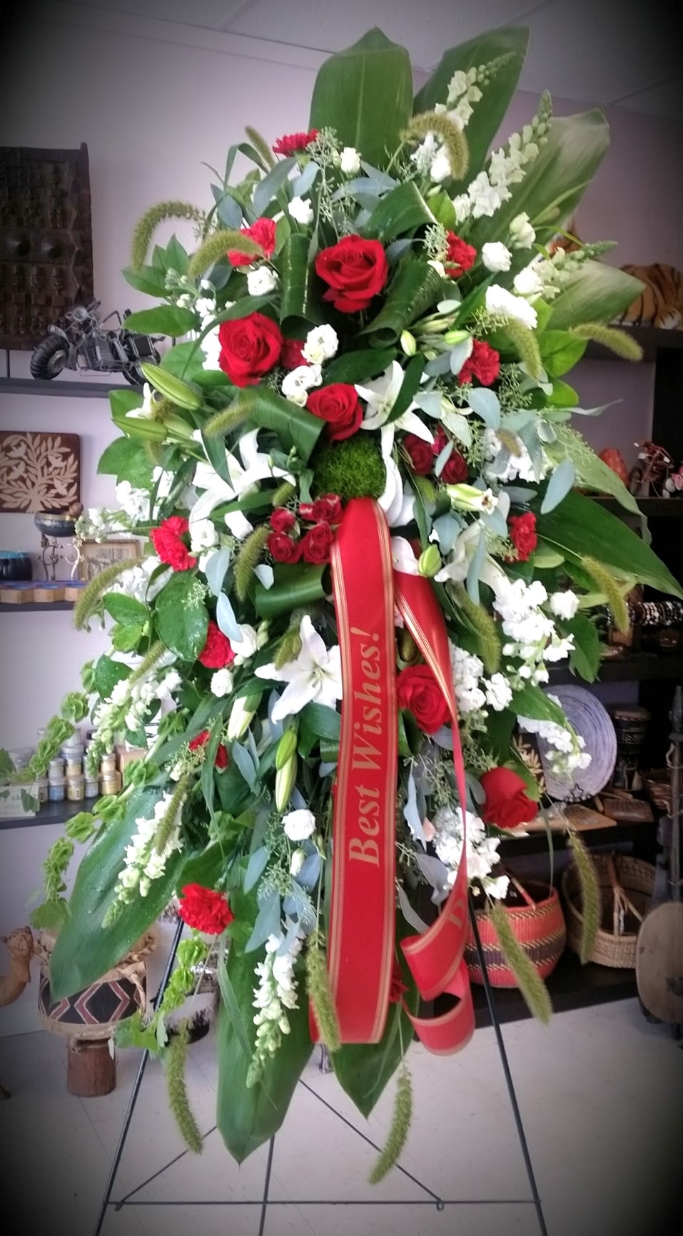 Red & White Tribute Red & White Tribute - Pure white lilies and dendrobium orchids mingle with red roses, white asiatic lilies and more in this magnificent and impressive standing spray of the finest blooms. A fitting tribute for a funeral, wake or memorial service.
