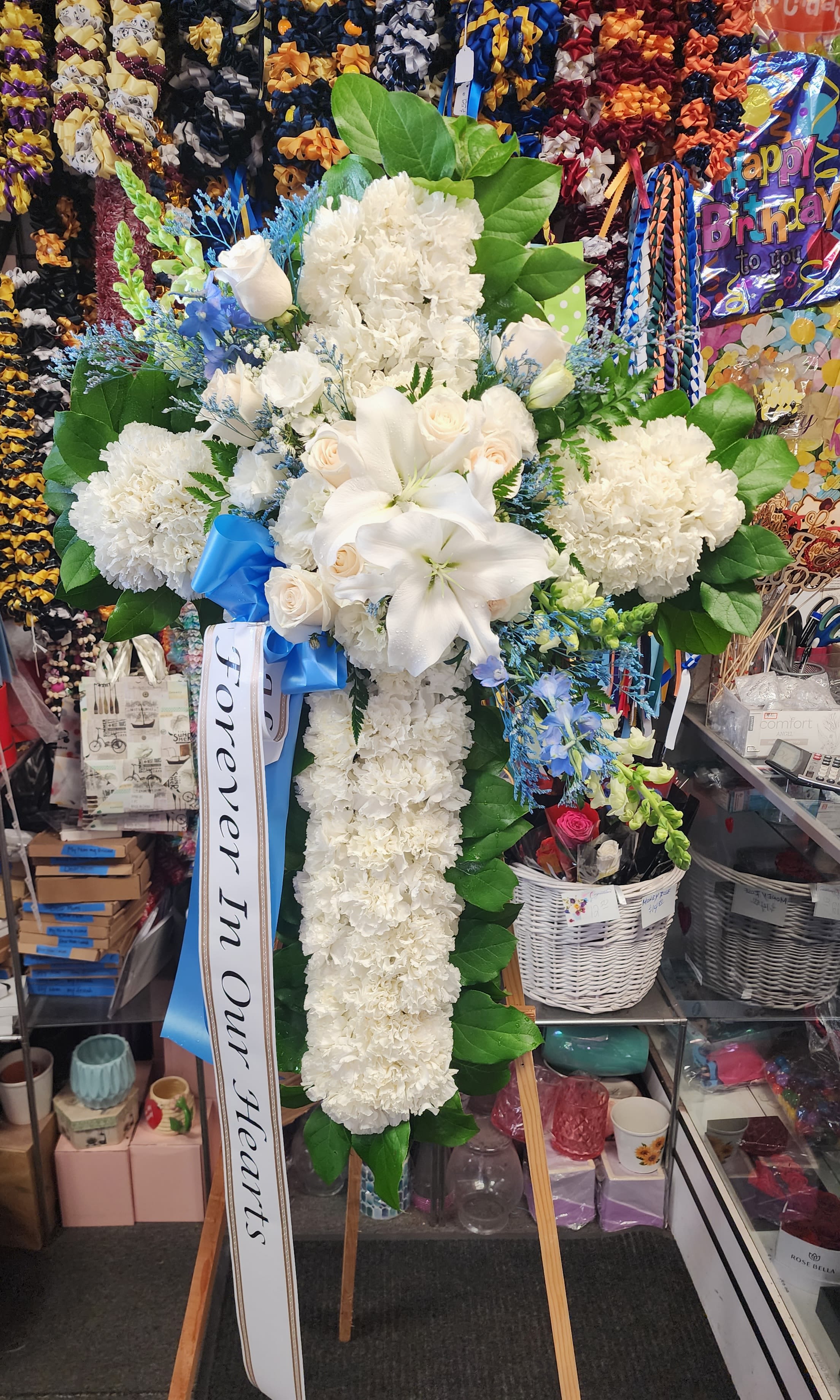 Crossing Over - Pride, dignity, admiration and faith are on beautiful display in this moving sympathy arrangement. It's a meaningful way to deliver your heartfelt message.  Small 20&quot; x 30&quot; Deluxe 22&quot; x 34&quot; Premium 24&quot; x 38&quot;