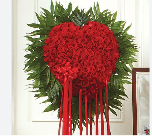 Red Rose Bleeding Heart Red Rose Bleeding Heart - This solid Heart-shaped arrangement makes an unforgettable statement and a stunning tribute for the loss of your loved one. Crafted from 150 fresh red roses in a solid heart. Large measures approximately 36"H x 30"W and stands on a 6foot tall easel.
