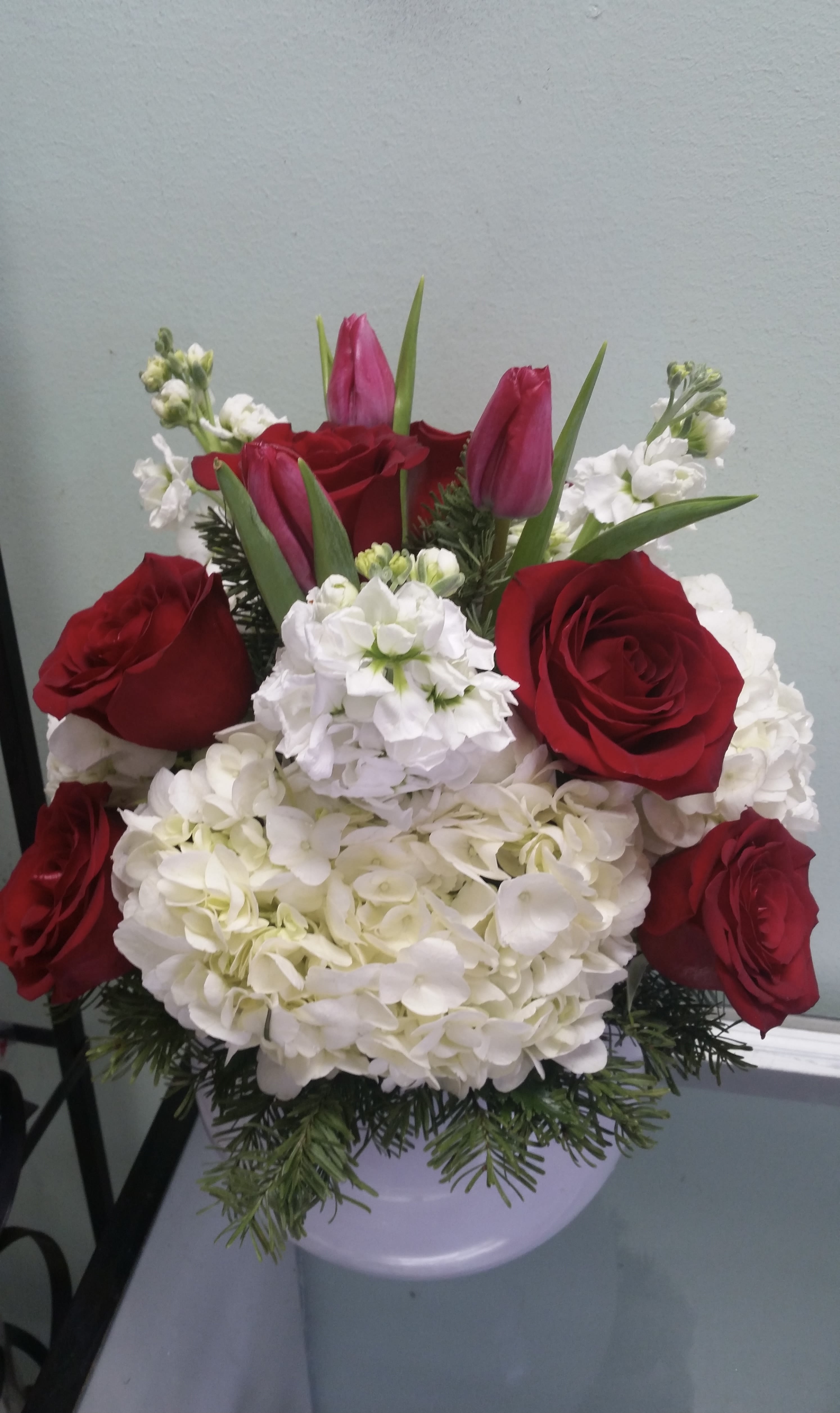 Touch of Winter Touch of Winter - Ceramic container with roses, tulips, stocks, and hydrangeas.