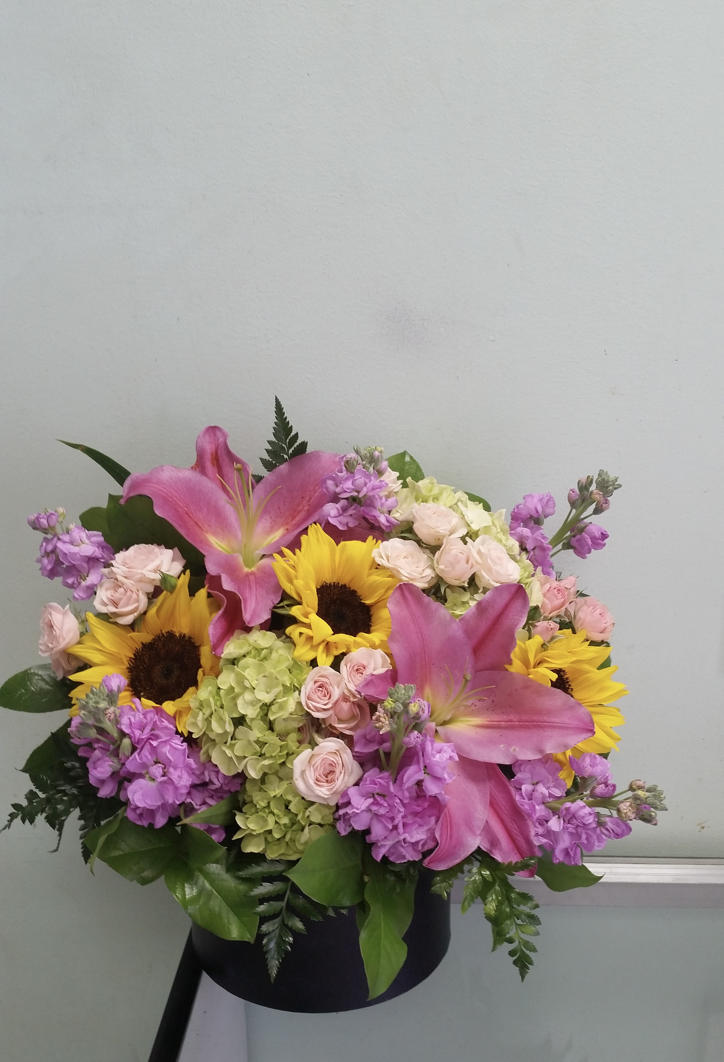 Blooming Beauty Blooming Beauty - Box arrangement with lilies, sunflowers, spray roses, hydrangeas, and stocks.
